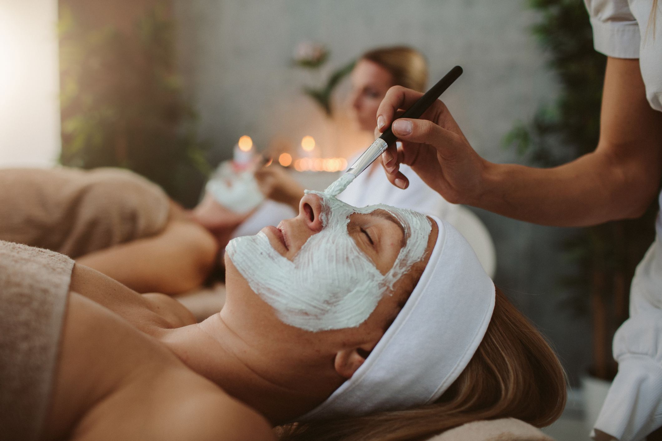 Mother and adult daughter enjoy beauty treatment in a spa center