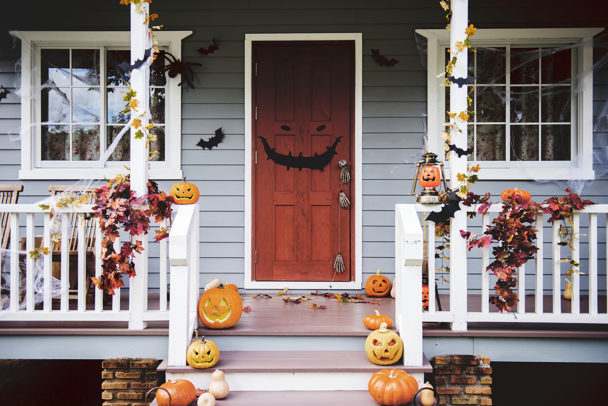 Halloween pumpkins and decorations outside a house