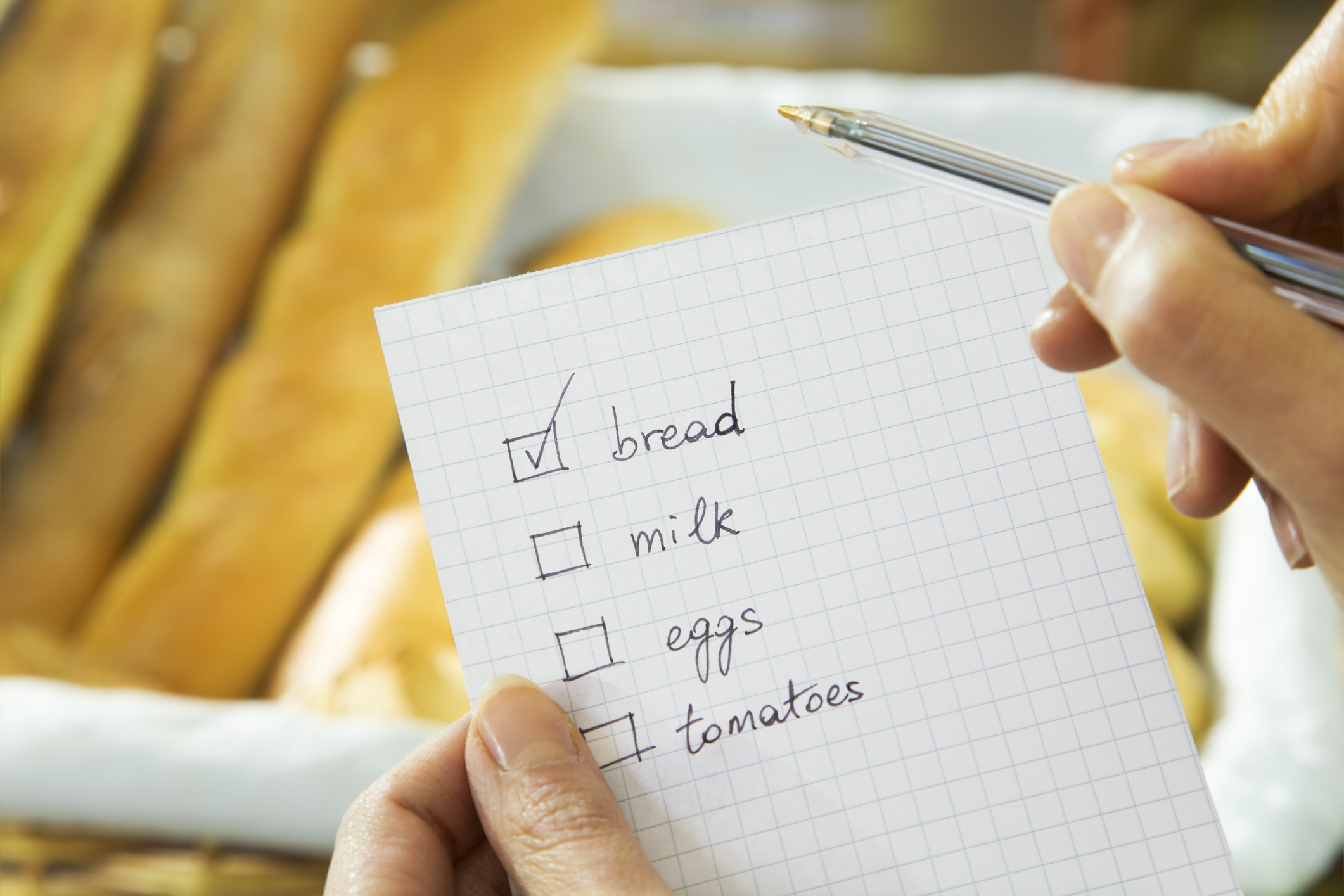 Close-up Grocery list bread checked off with baguettes