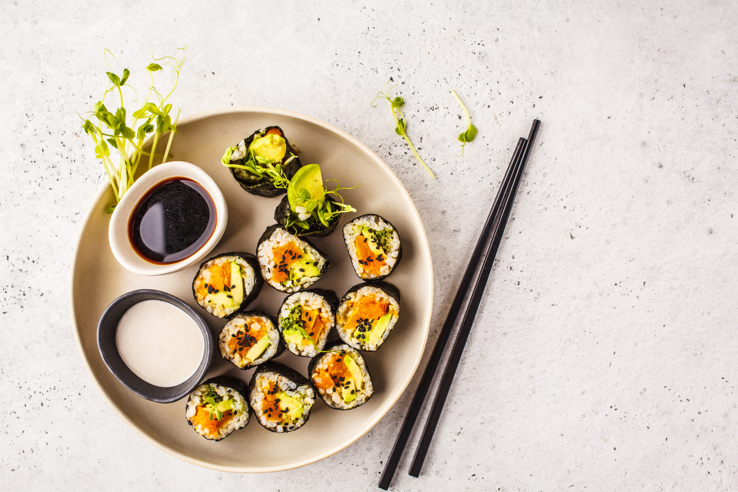 Vegan sushi rolls with pumpkin, brown rice and avocado, top view.