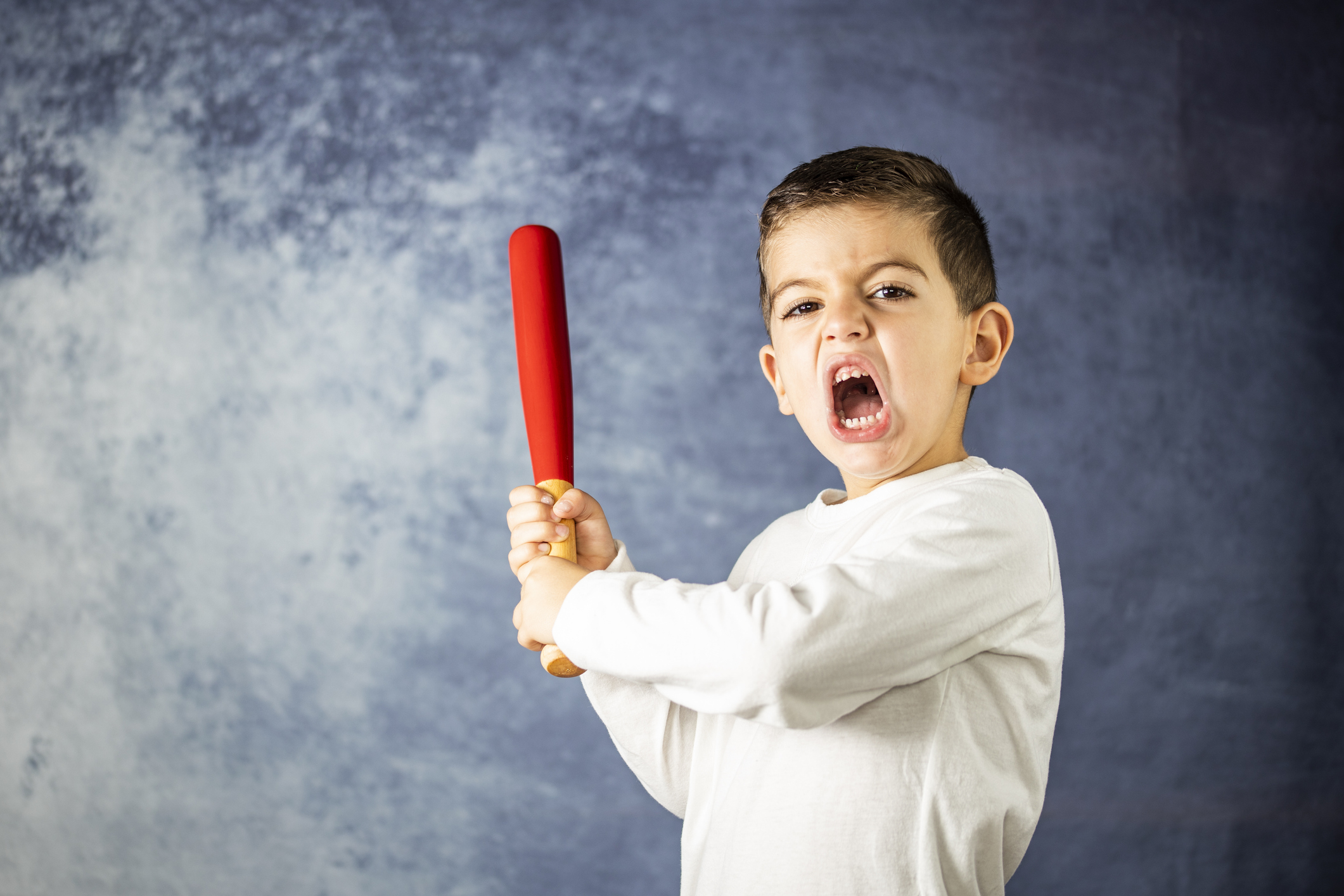 Little kid screaming with a bat in his hands