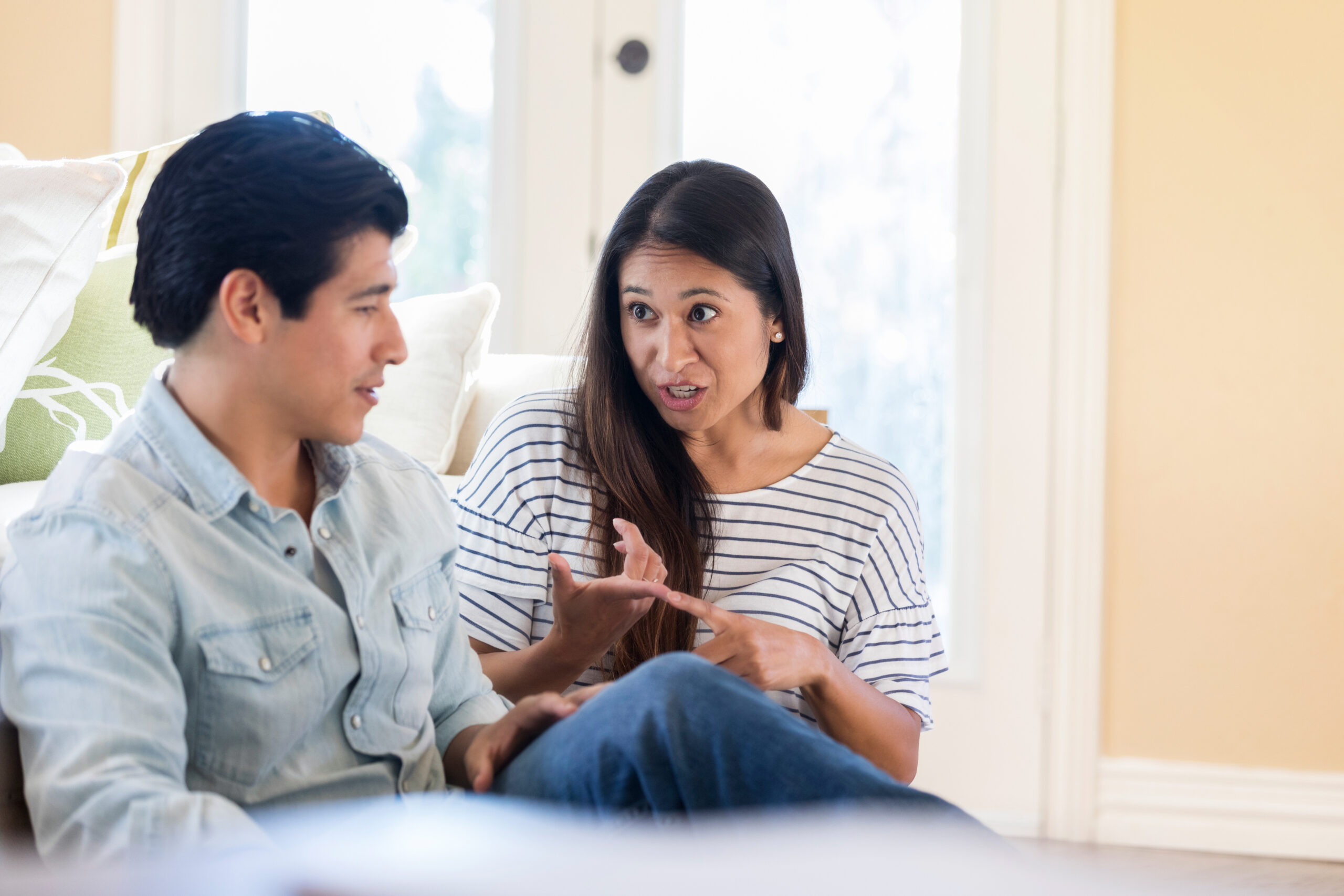 Husband and wife in serious discussion at home