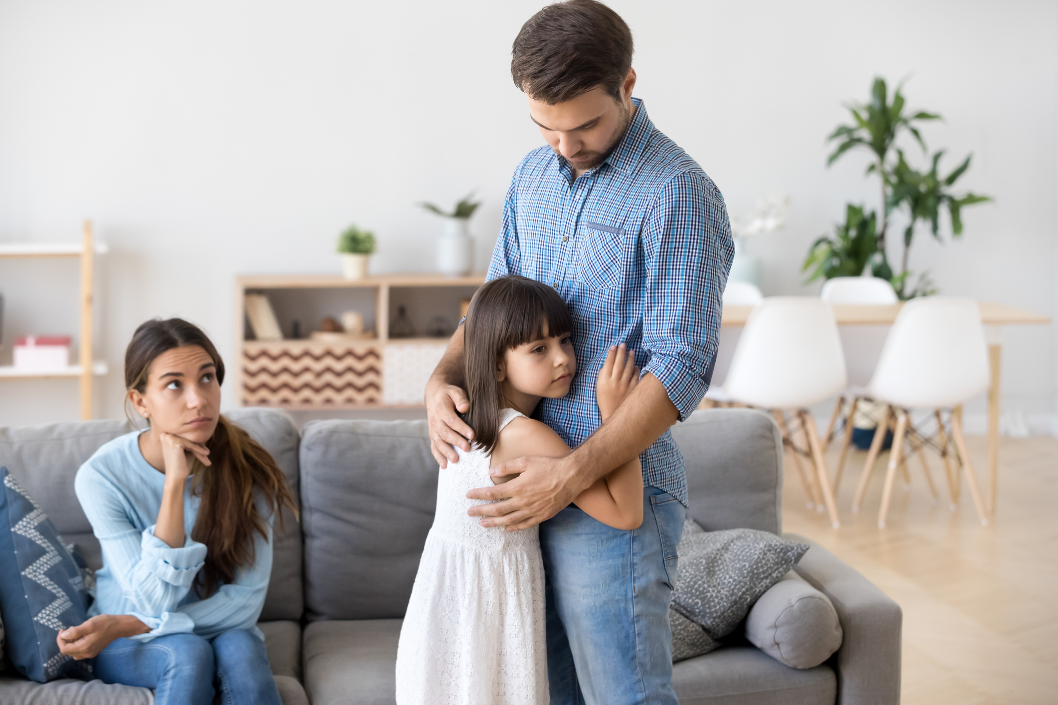 Unhappy family in living room daughter embrace father