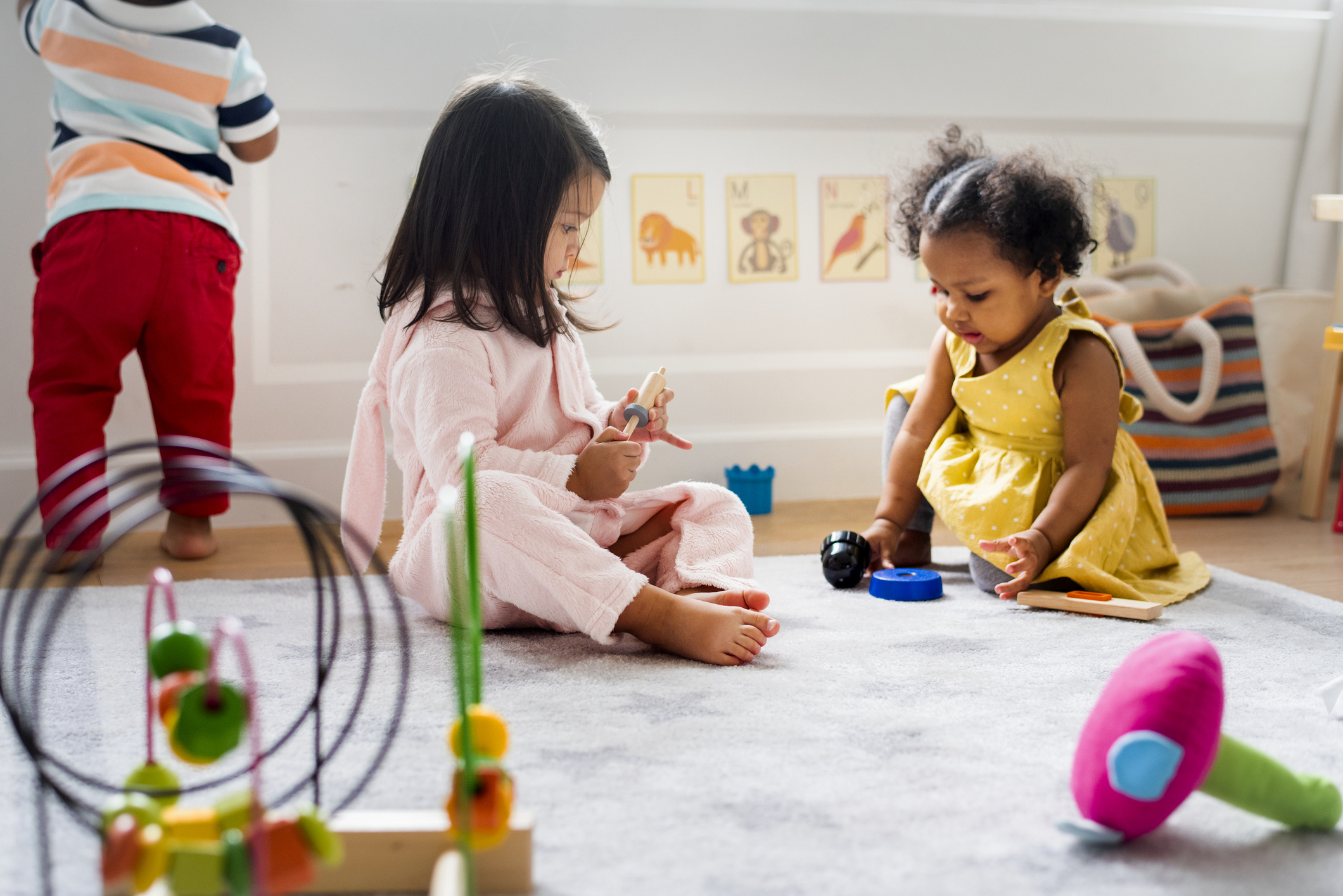 Little kids playing toys in the playroom