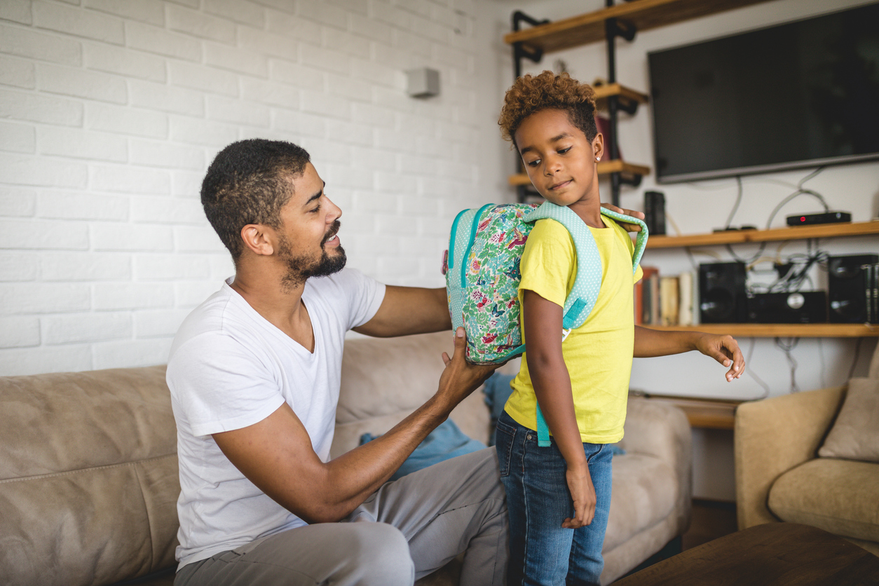 Father and a first grade child preparing for a school day