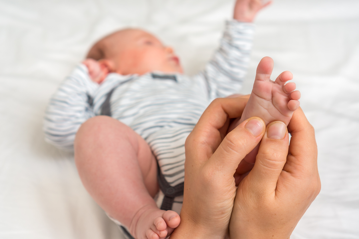 Mother makes foot massage for her baby