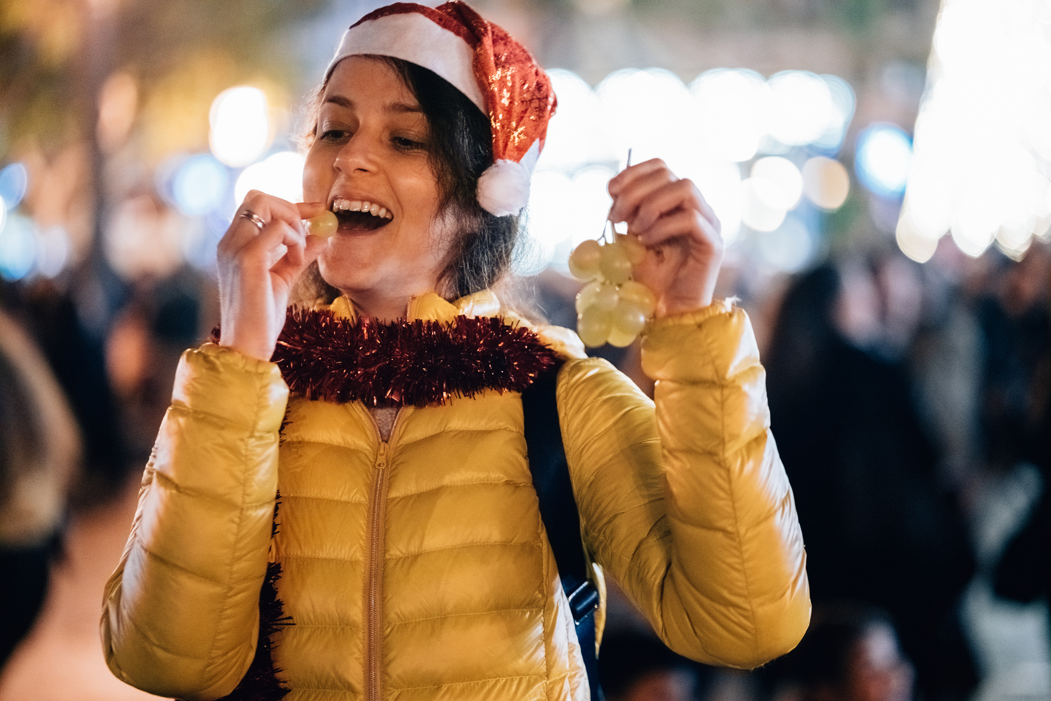 Woman eating grape at New Year's eve in Spain