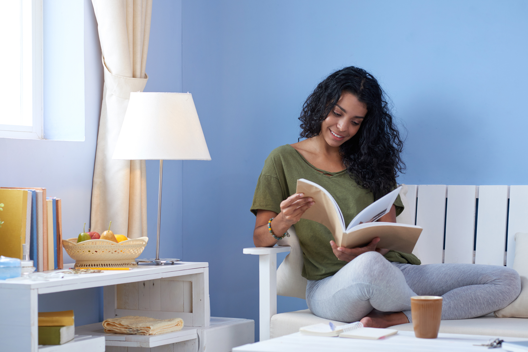 Young woman reading magazine