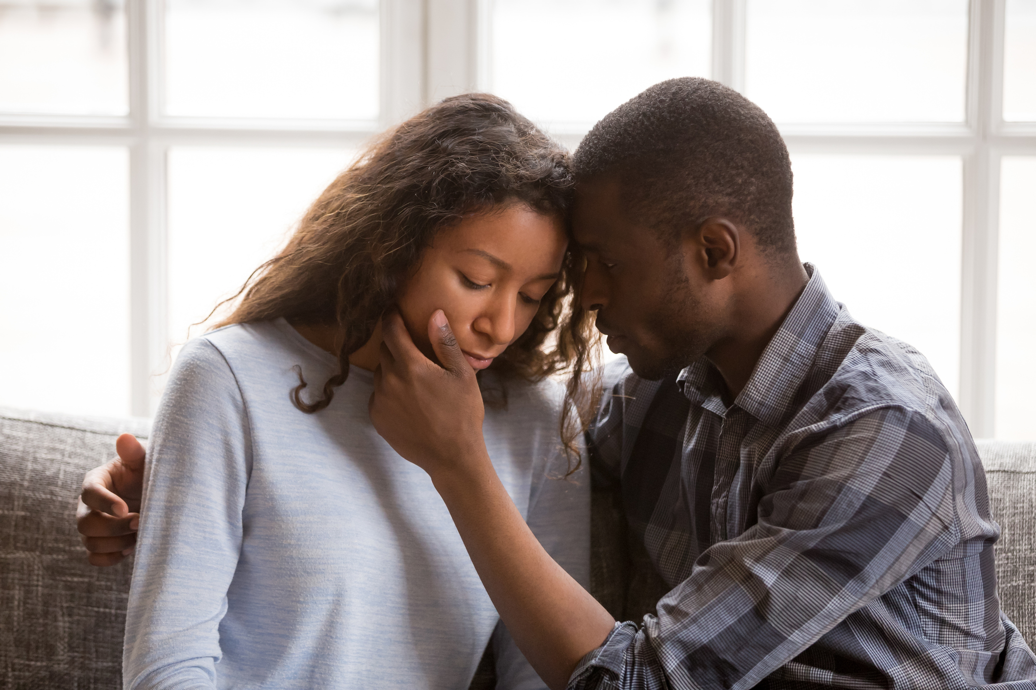 Loving African American husband touching wife face