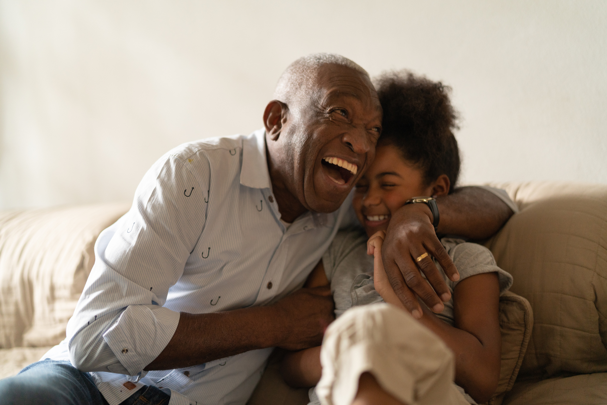 Grandfather Playing with Her Granddaughter at Home