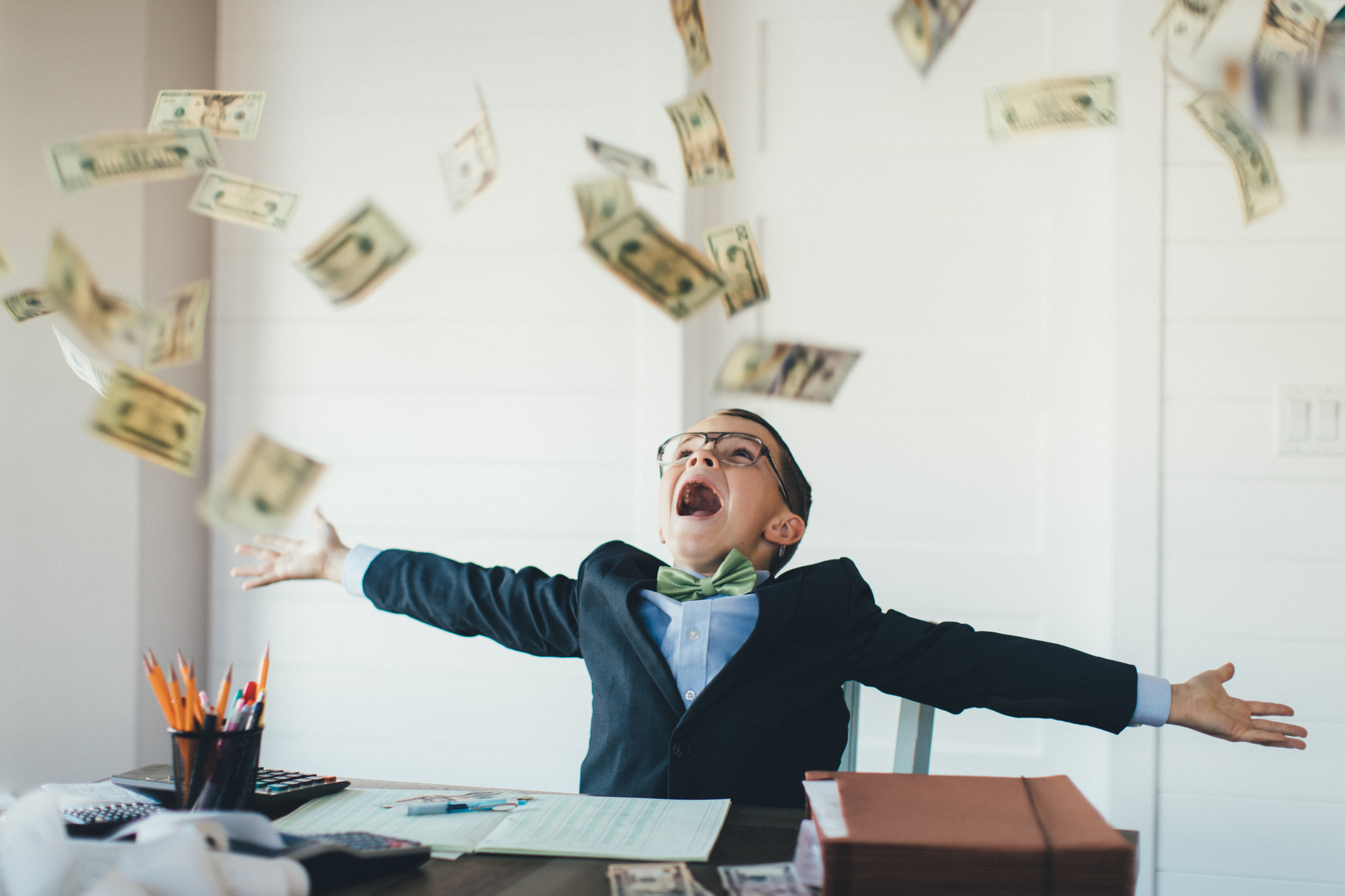 Young Boy Businessman Catching Falling Money