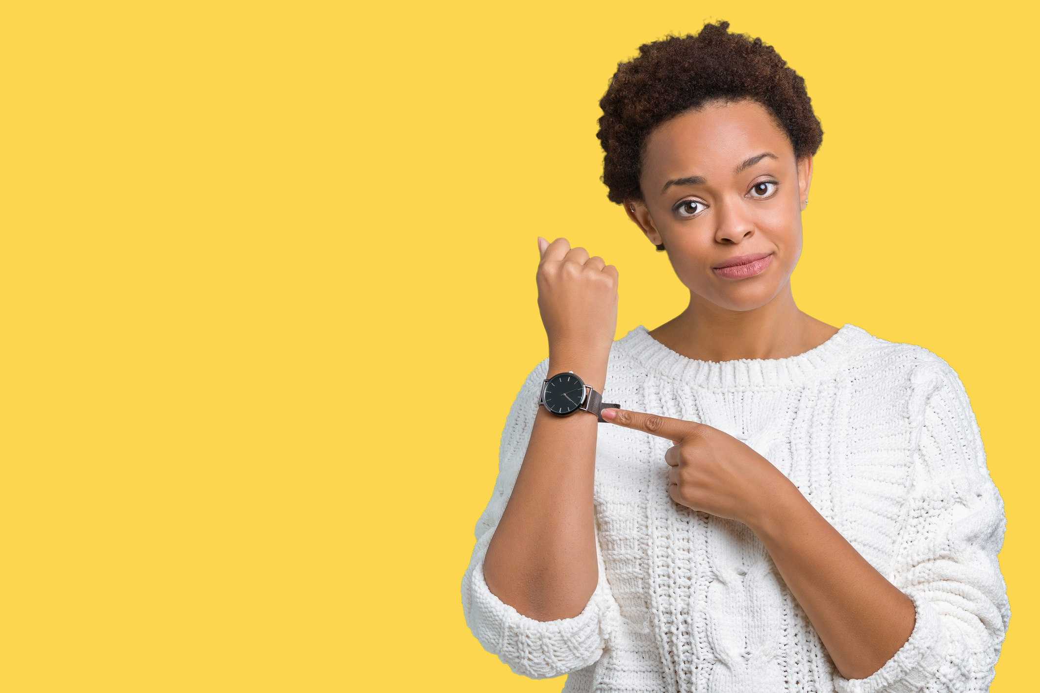 Beautiful young african american woman wearing sweater over isolated background In hurry pointing to watch time, impatience, upset and angry for deadline delay