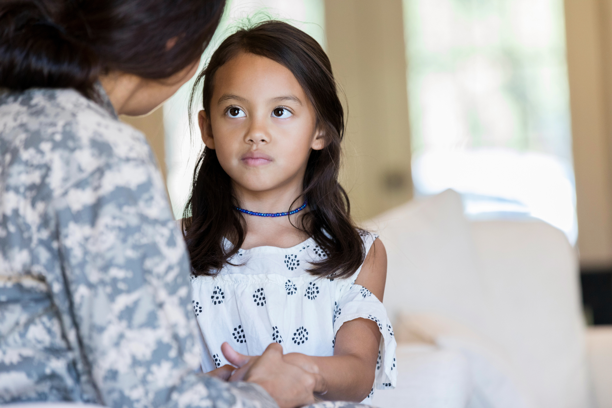 Young girl is sad to see her mom leave for military duty