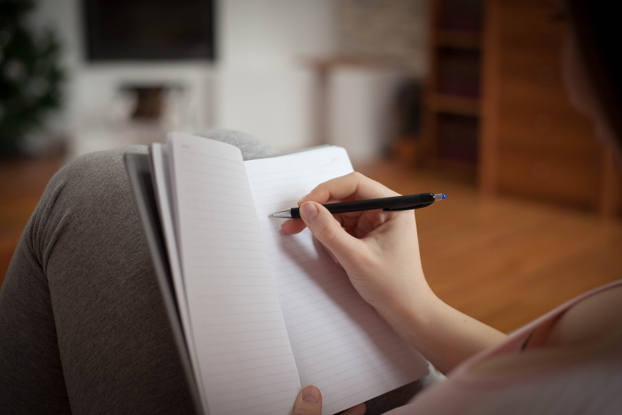 Pregnant woman writing names for her baby .