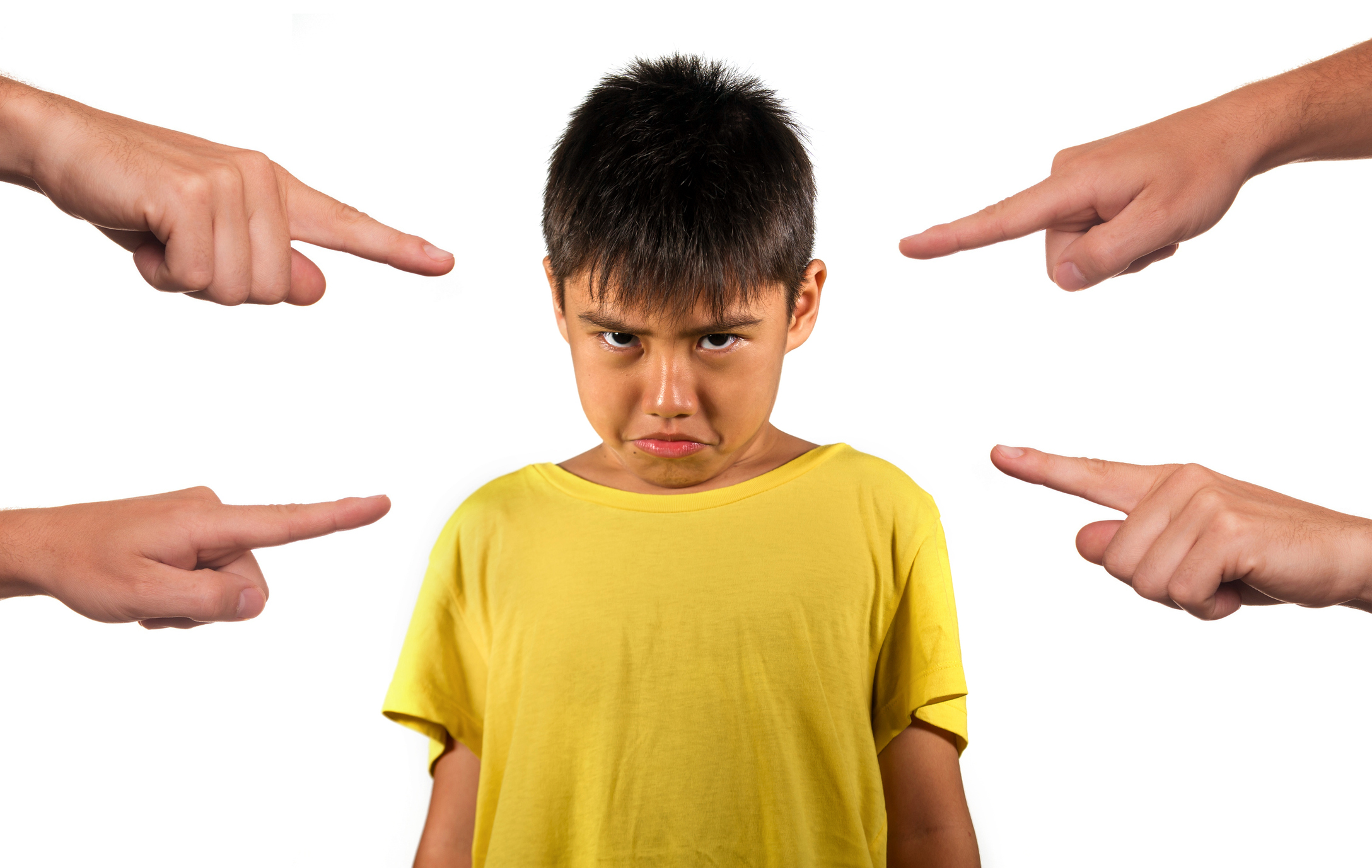 group of hands pointing finger to young sad and stressed schoolboy feeling scared victim of abuse and bullying isolated on white background in kid harassed and bullied at school concept