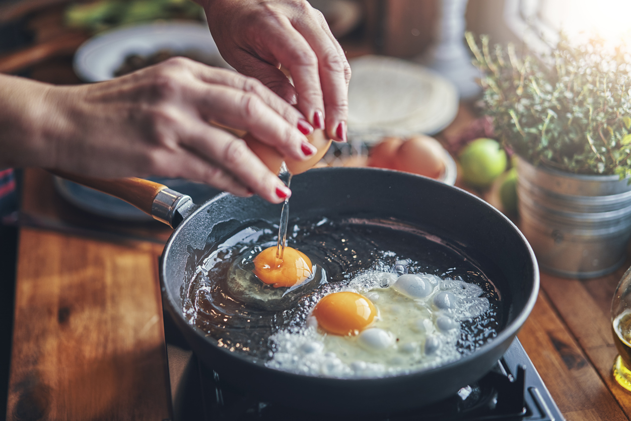 Frying Egg in a Cooking Pan in Domestic Kitchen