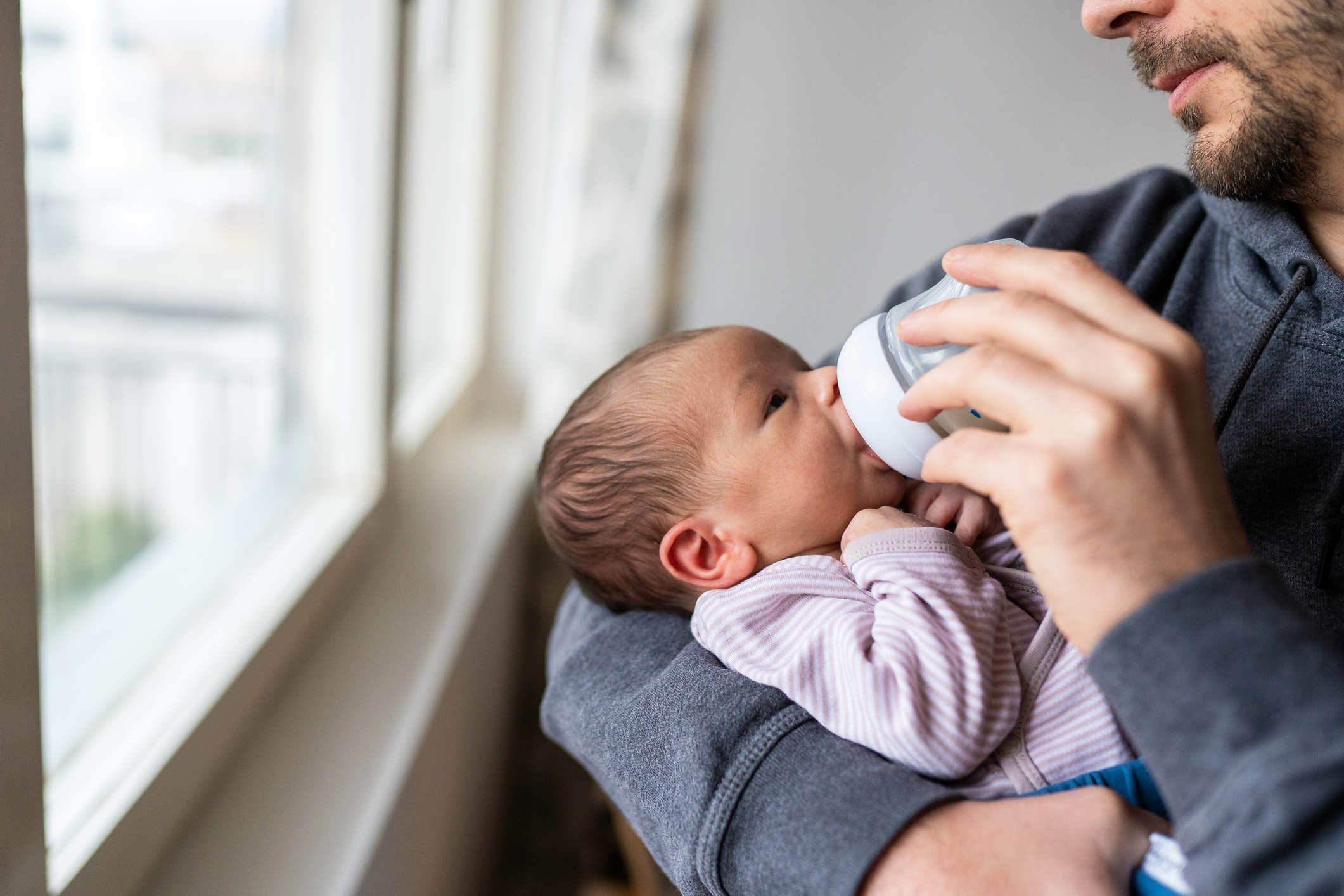 Daddy feeding newborn baby