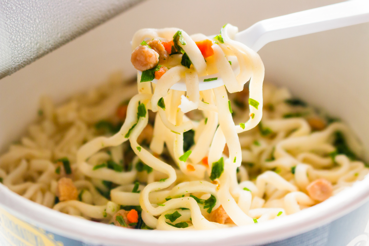 plastic fork with ramen noodles close-up