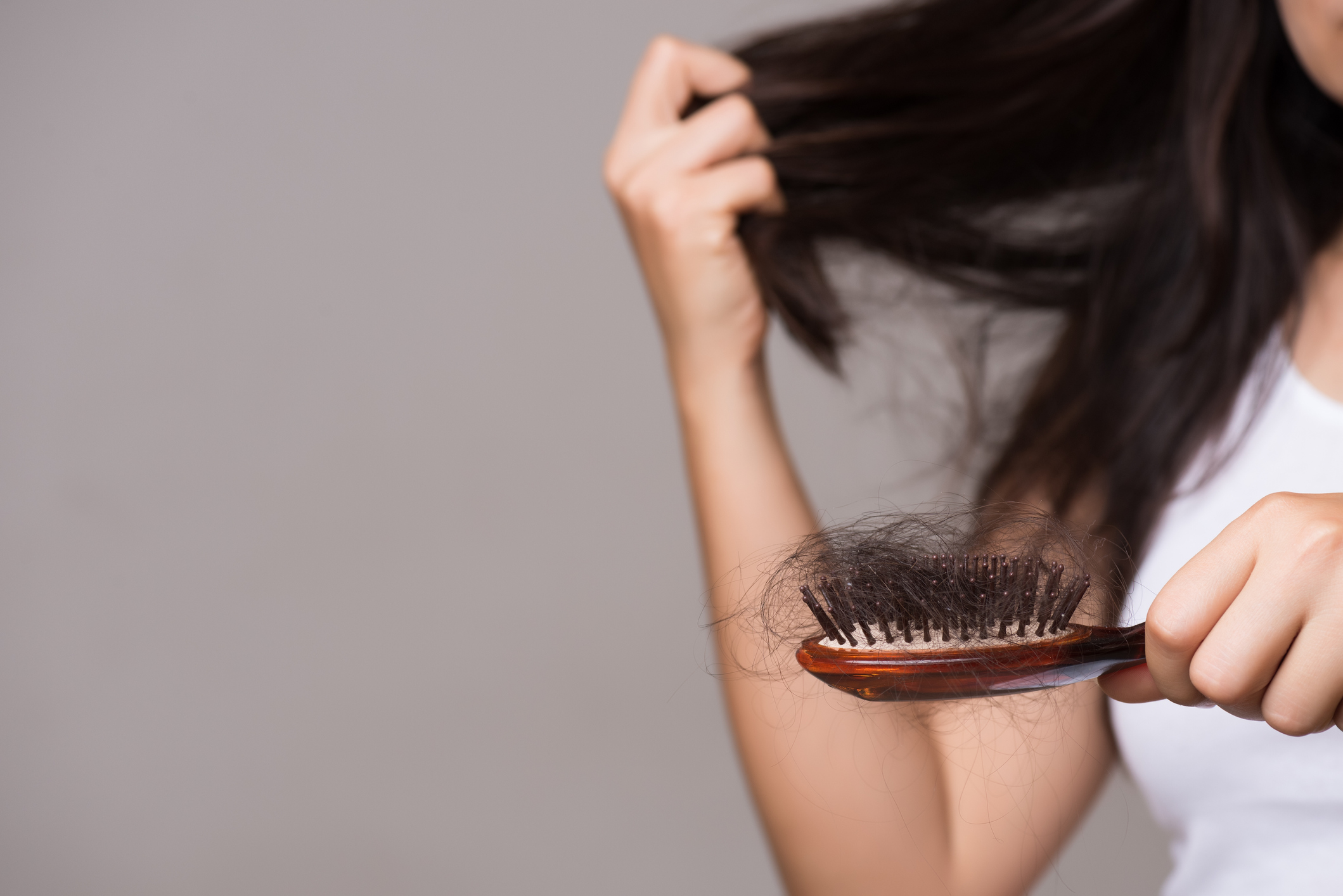 Healthy concept. Woman show her brush with long loss hair and looking at her hair.