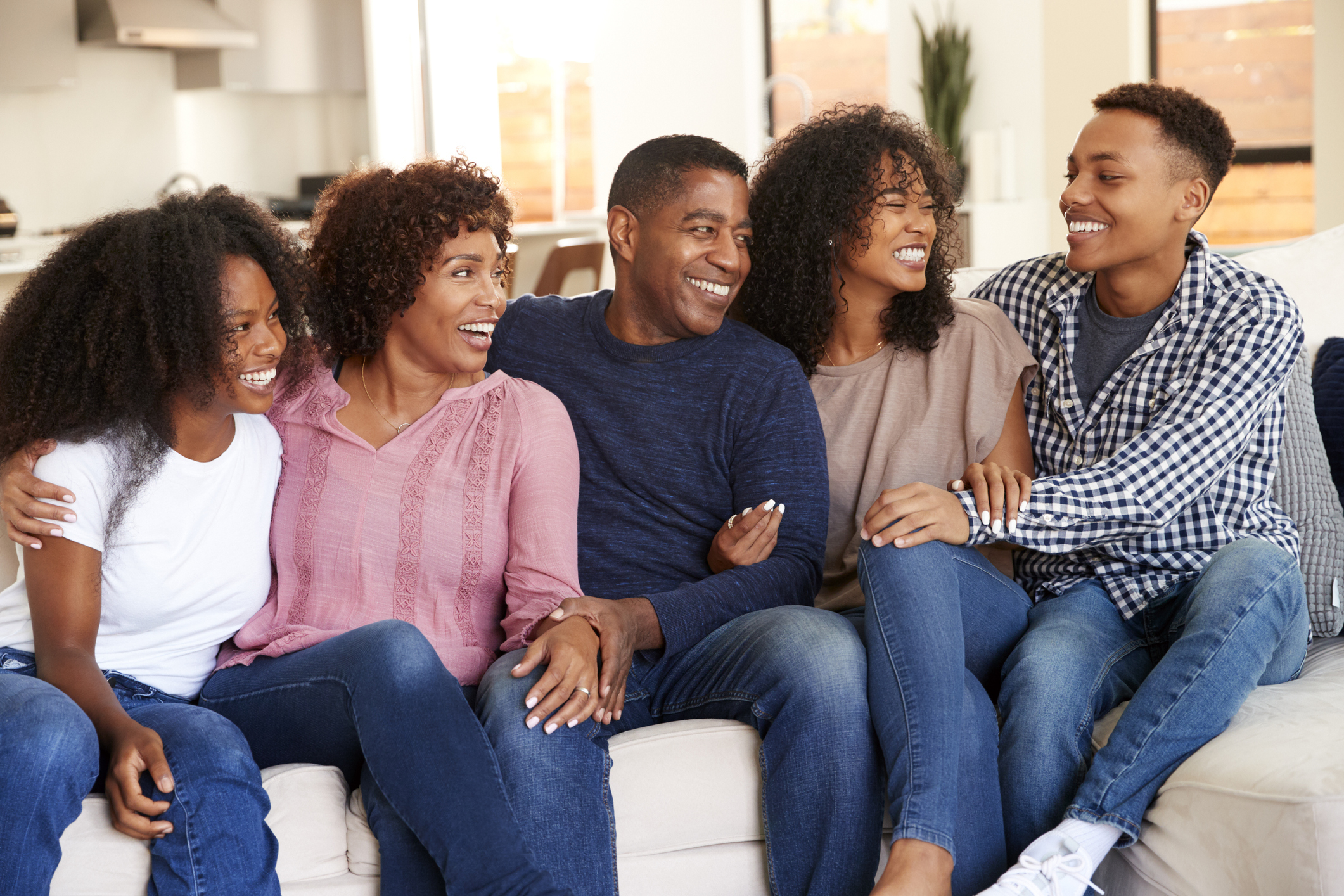 Parents relaxing at home with their teen and young adult kids