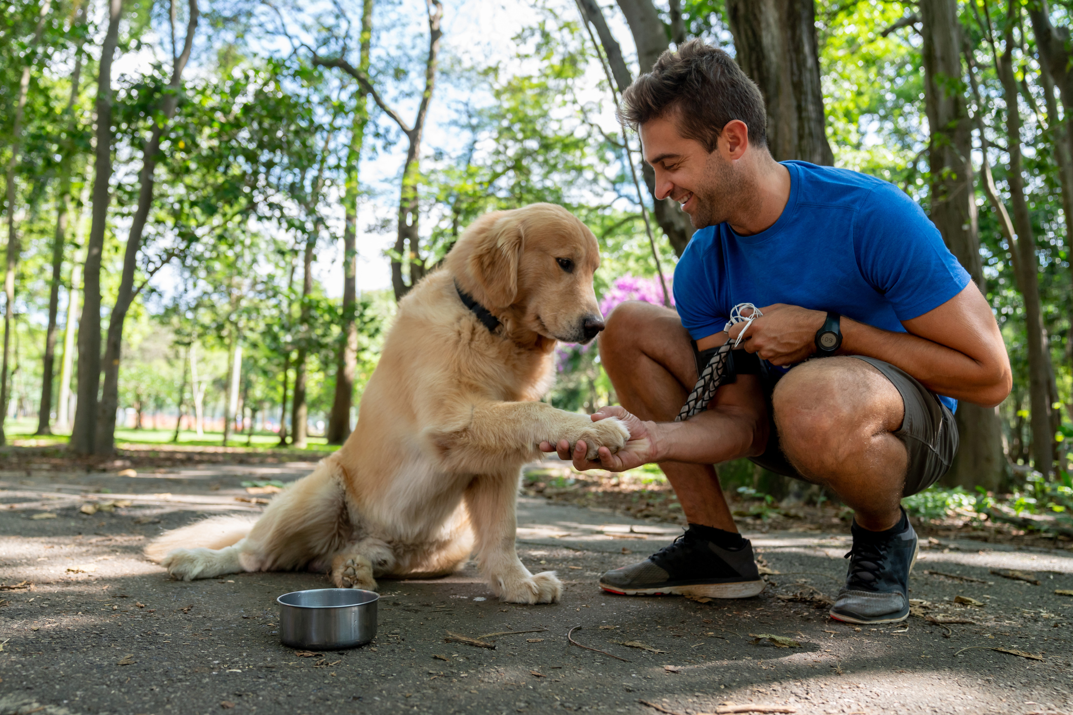 Happy man training with his dog at the park