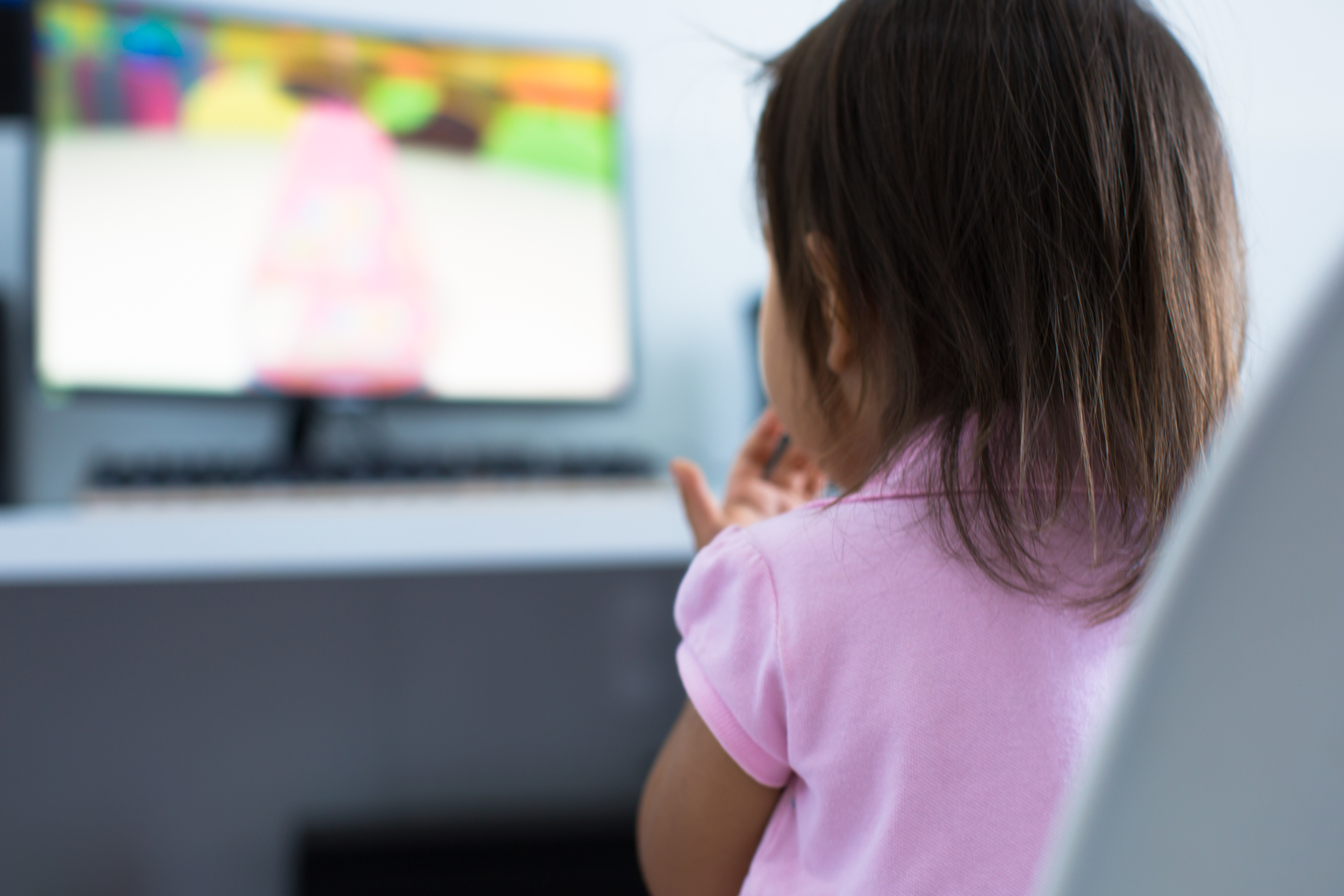 Young child watching tv on the computer at home