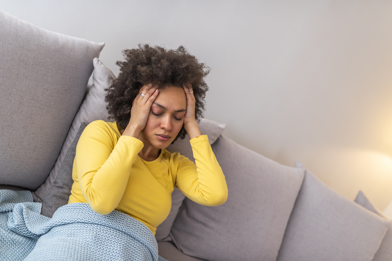 Young woman suffering from strong headache or migraine