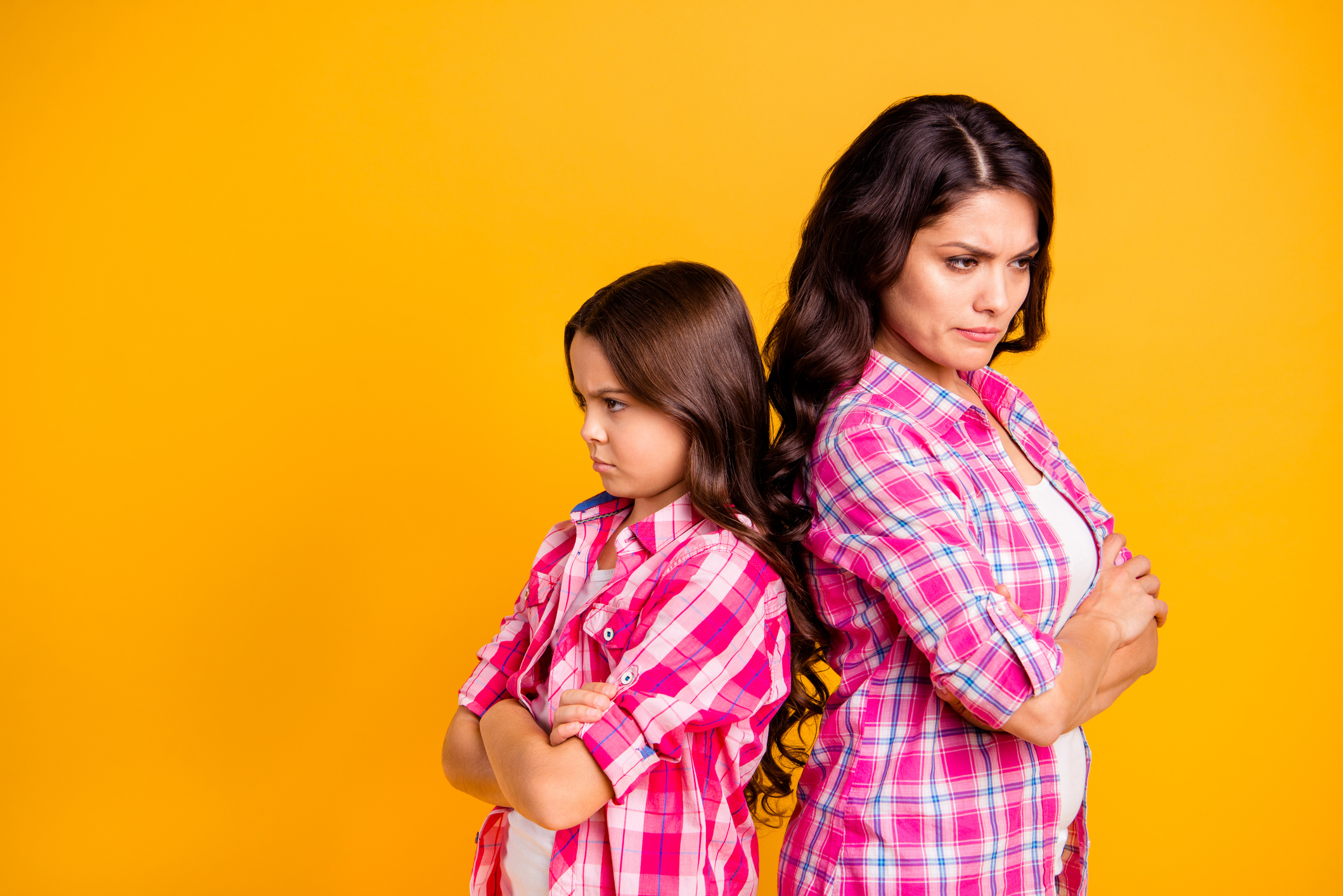 Portrait of depressed mature mom little kid parenthood concept feel irritated behave aggressive have disagreement stress wear trendy checkered shirts isolated on bright background