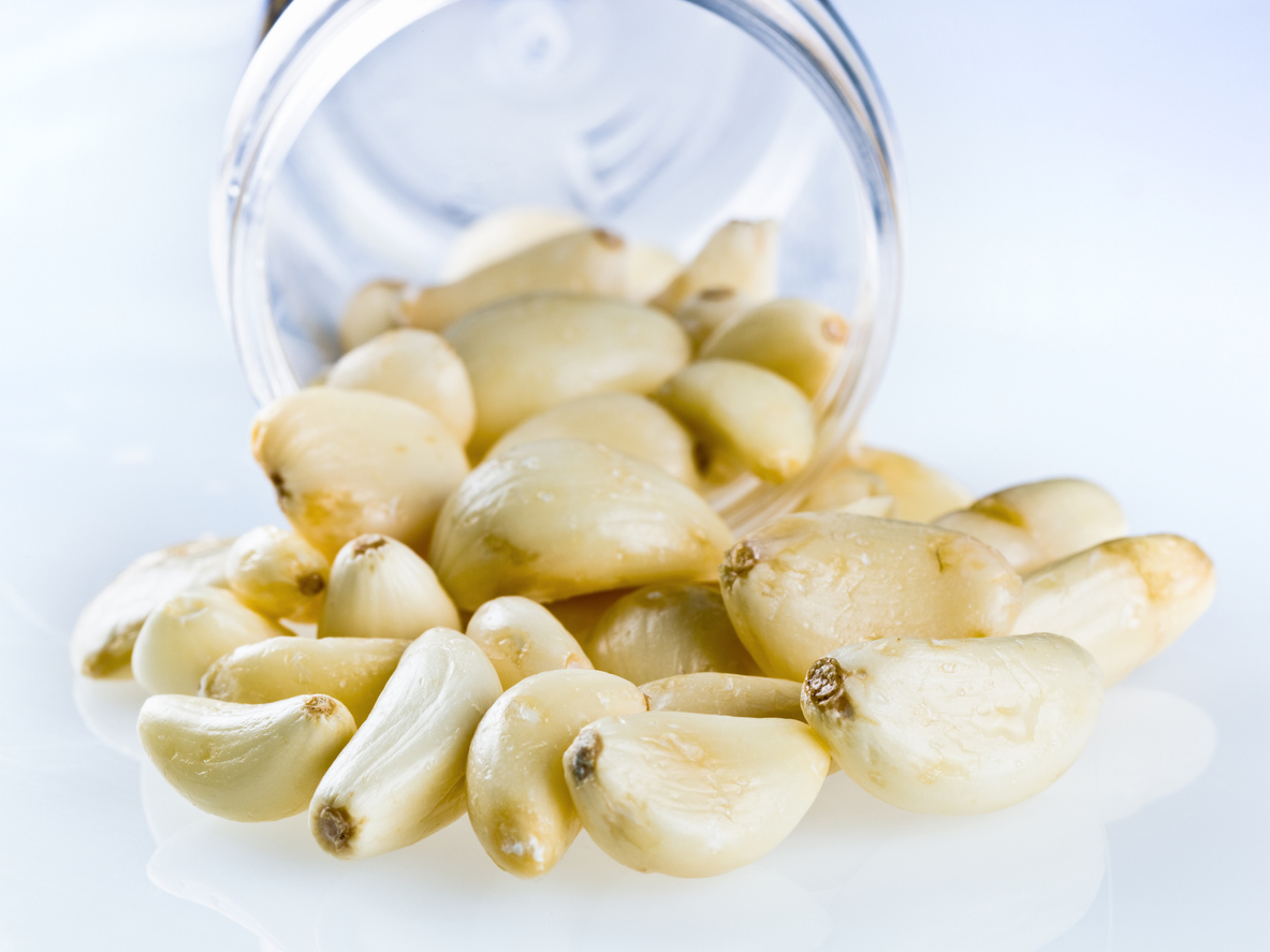 Open jar of peeled garlic cloves