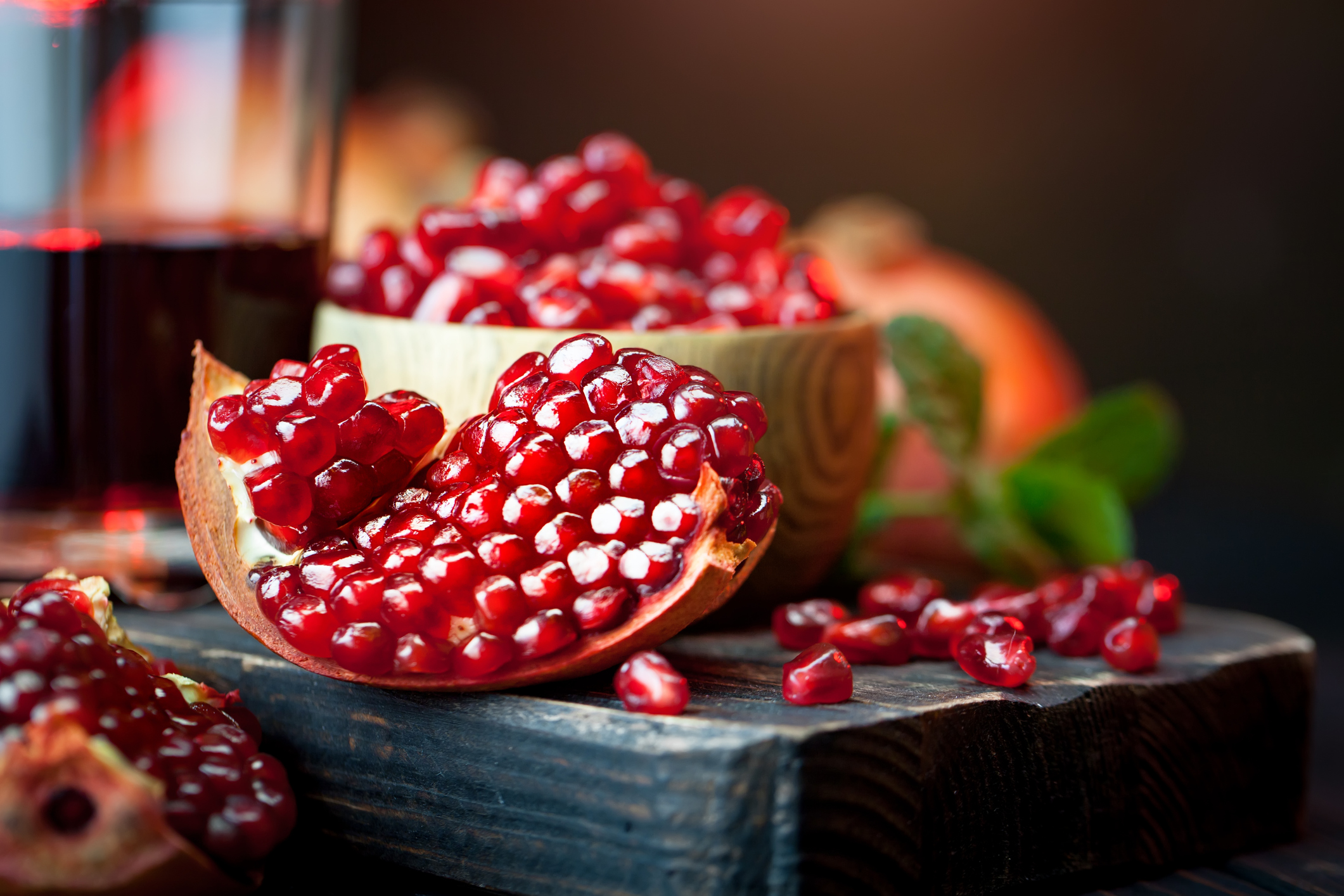 Ripe pomegranate fruit on a old black wooden vintage background. Selective focus.