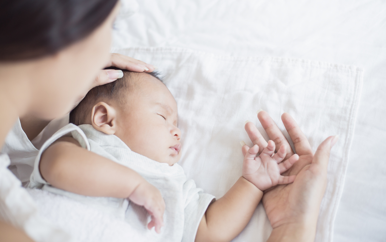 Mother Checks The Temperature Of A Sick Baby, newborn baby had a fever. Healthcare medical motherâs day concept