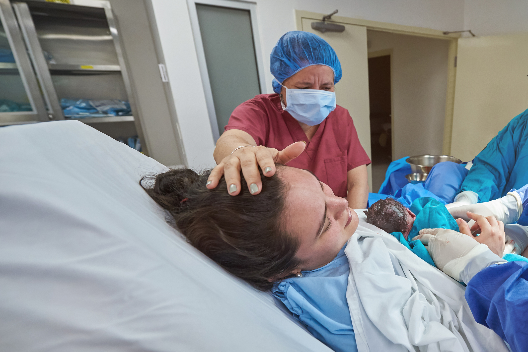 Young woman holding newborn baby