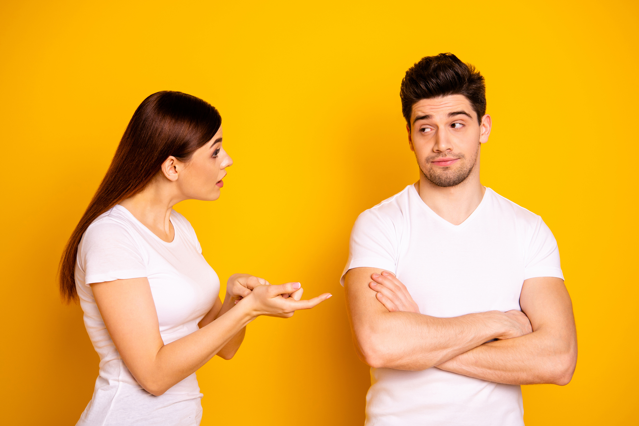 Close up side profile photo two beautiful people she her he him his blame aggression hands arms crossed folded not listen care lecture scolding wear casual white t-shirts isolated yellow background