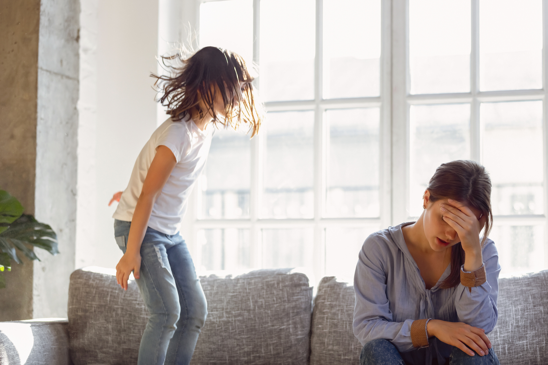 Upset mother having problem with noisy naughty daughter