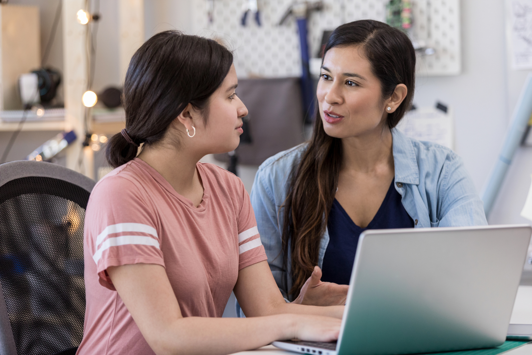 Hispanic aunt helps niece with homework