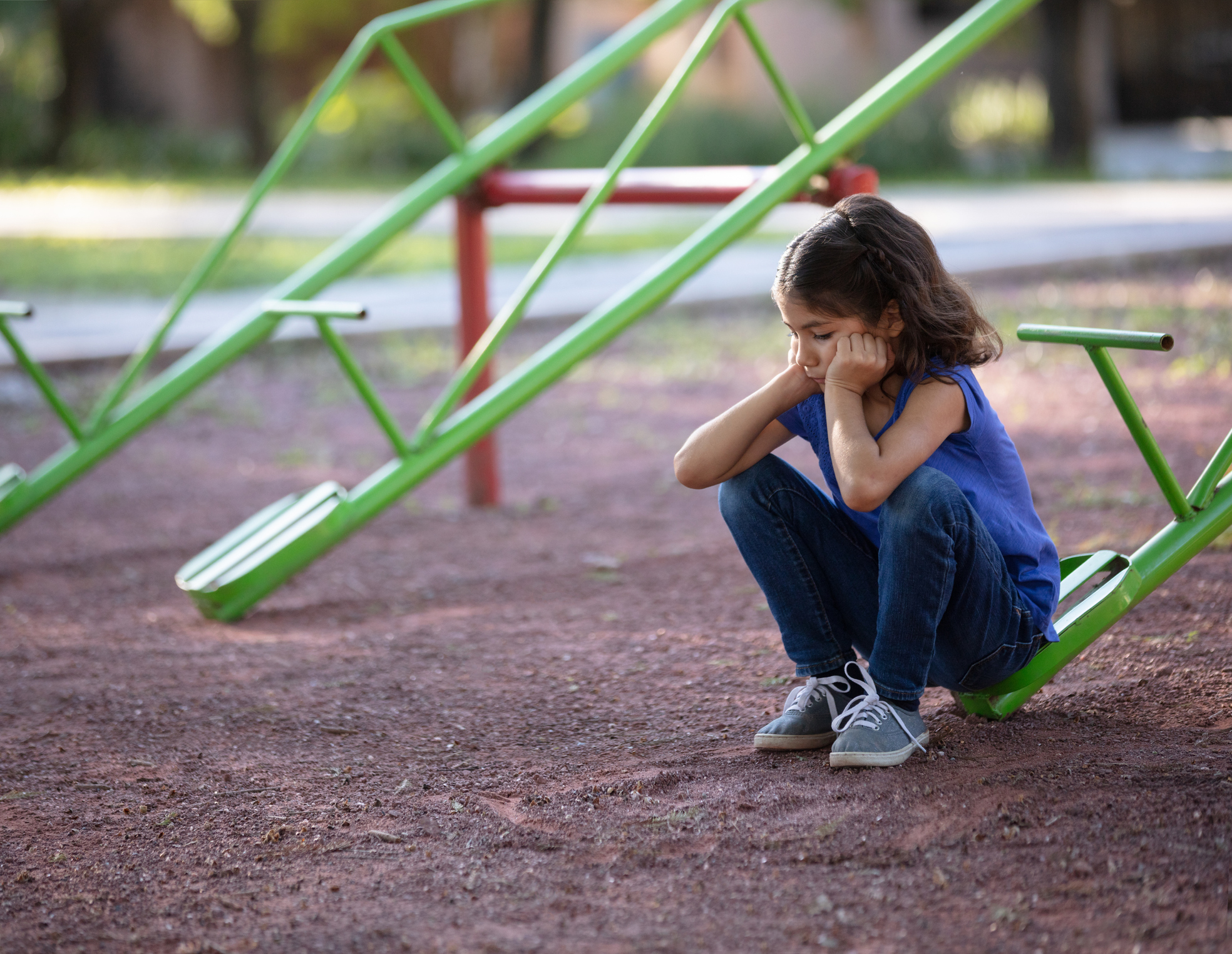 Girl with no one to play with on the teeter totter