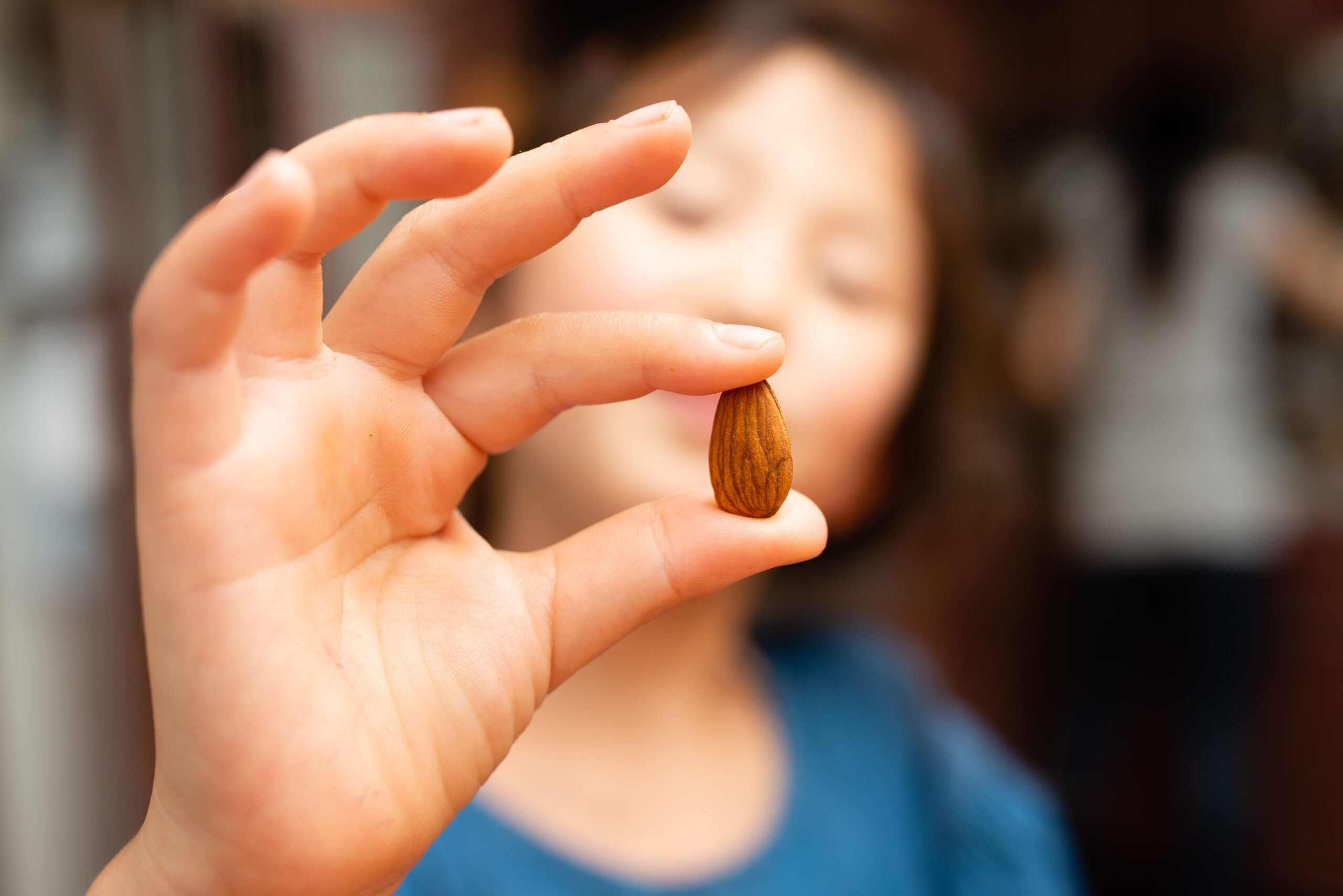 Child holding almond in hand