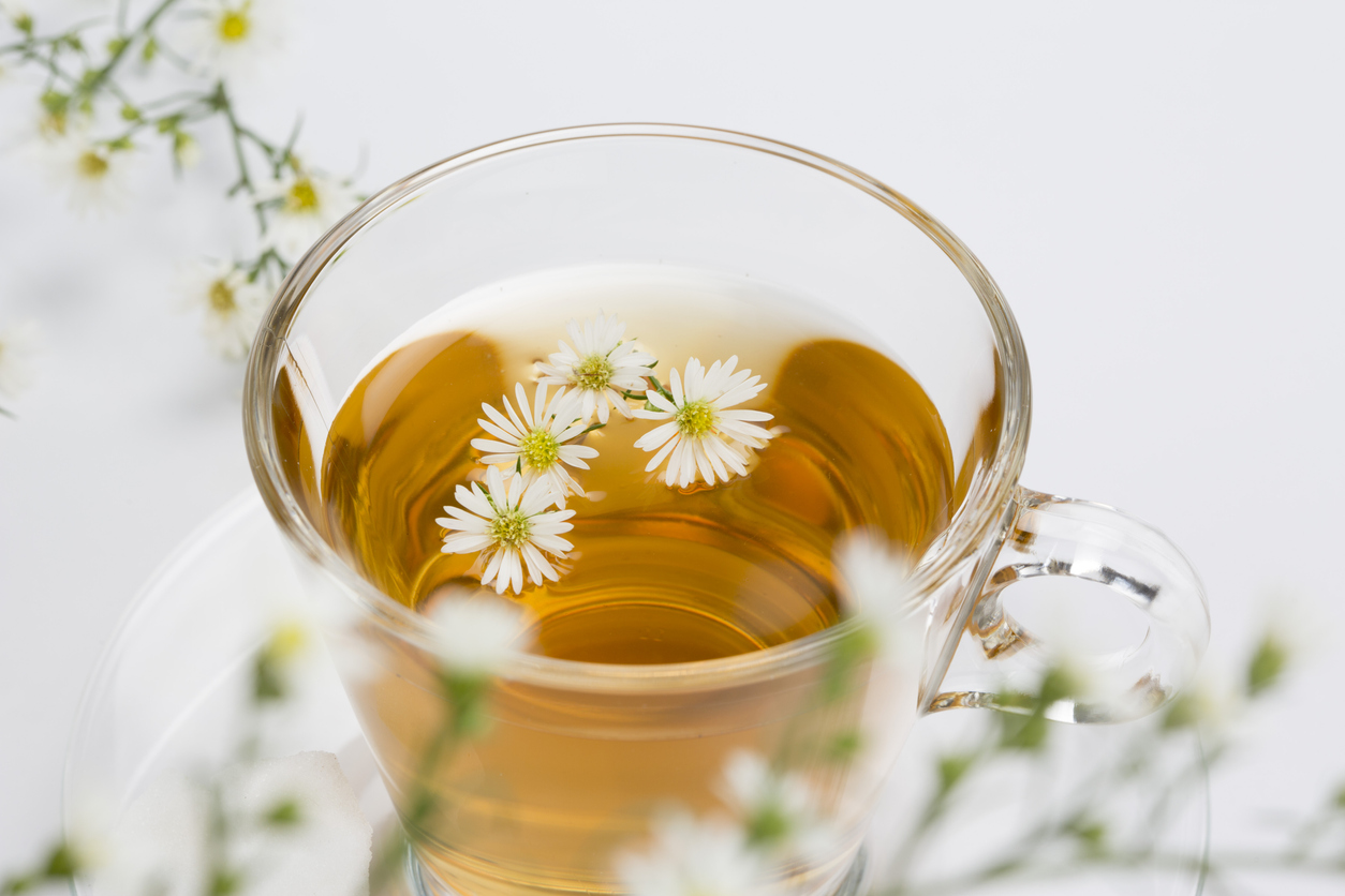 Cup of camomile tea with camomile flowers