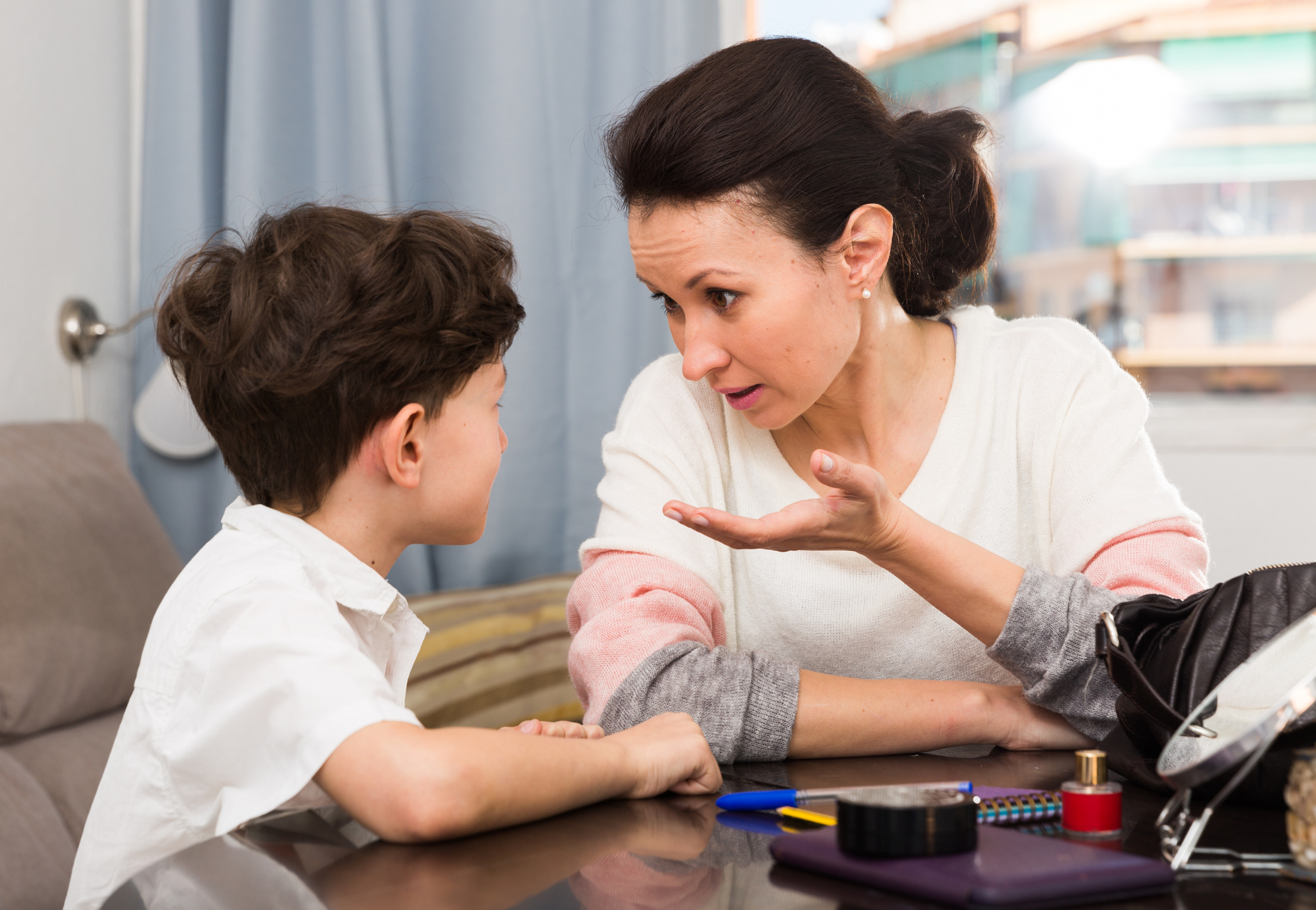 Annoyed mother discussing with son