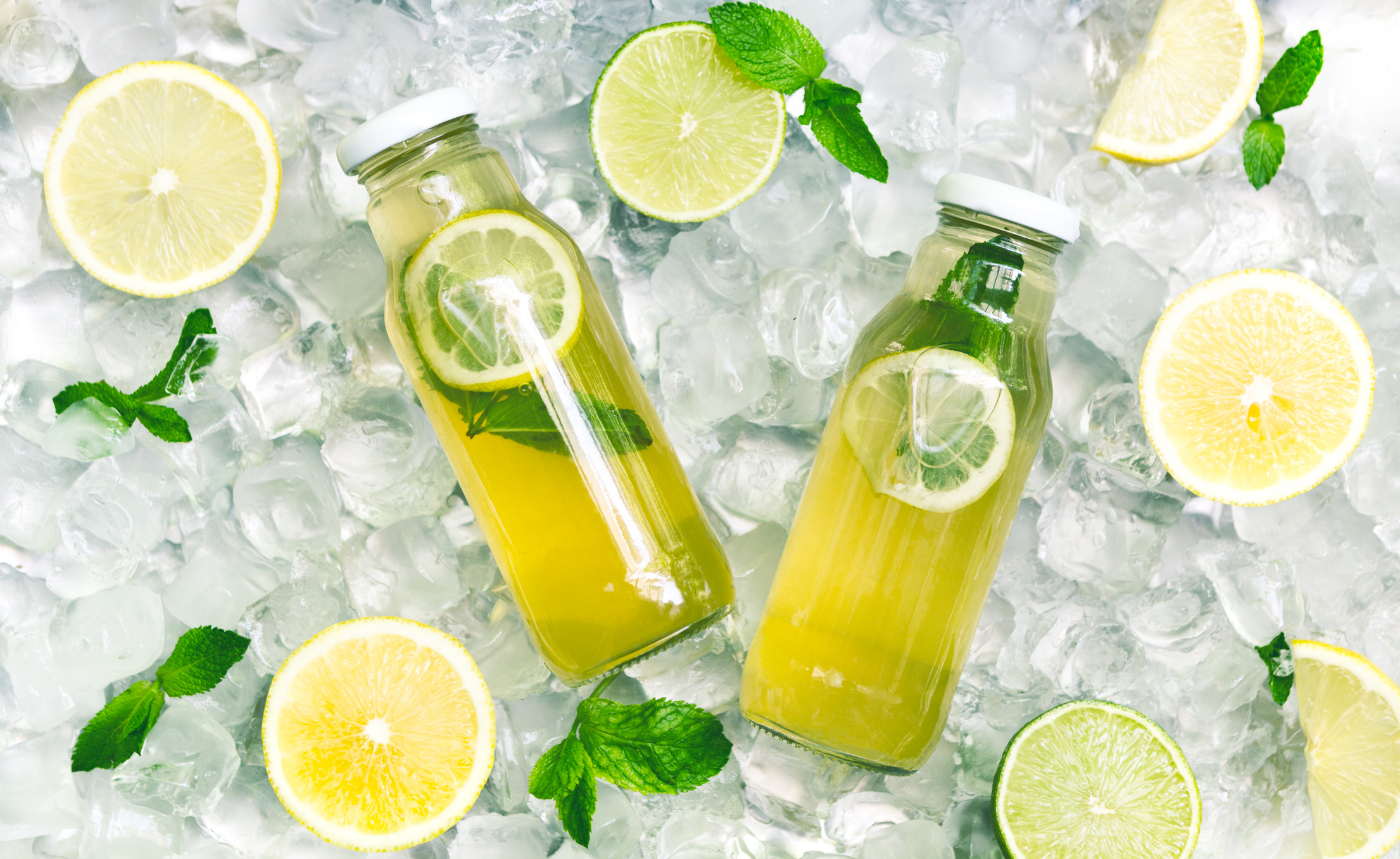 Fresh lemon cucamber detox water in glass jar on ice