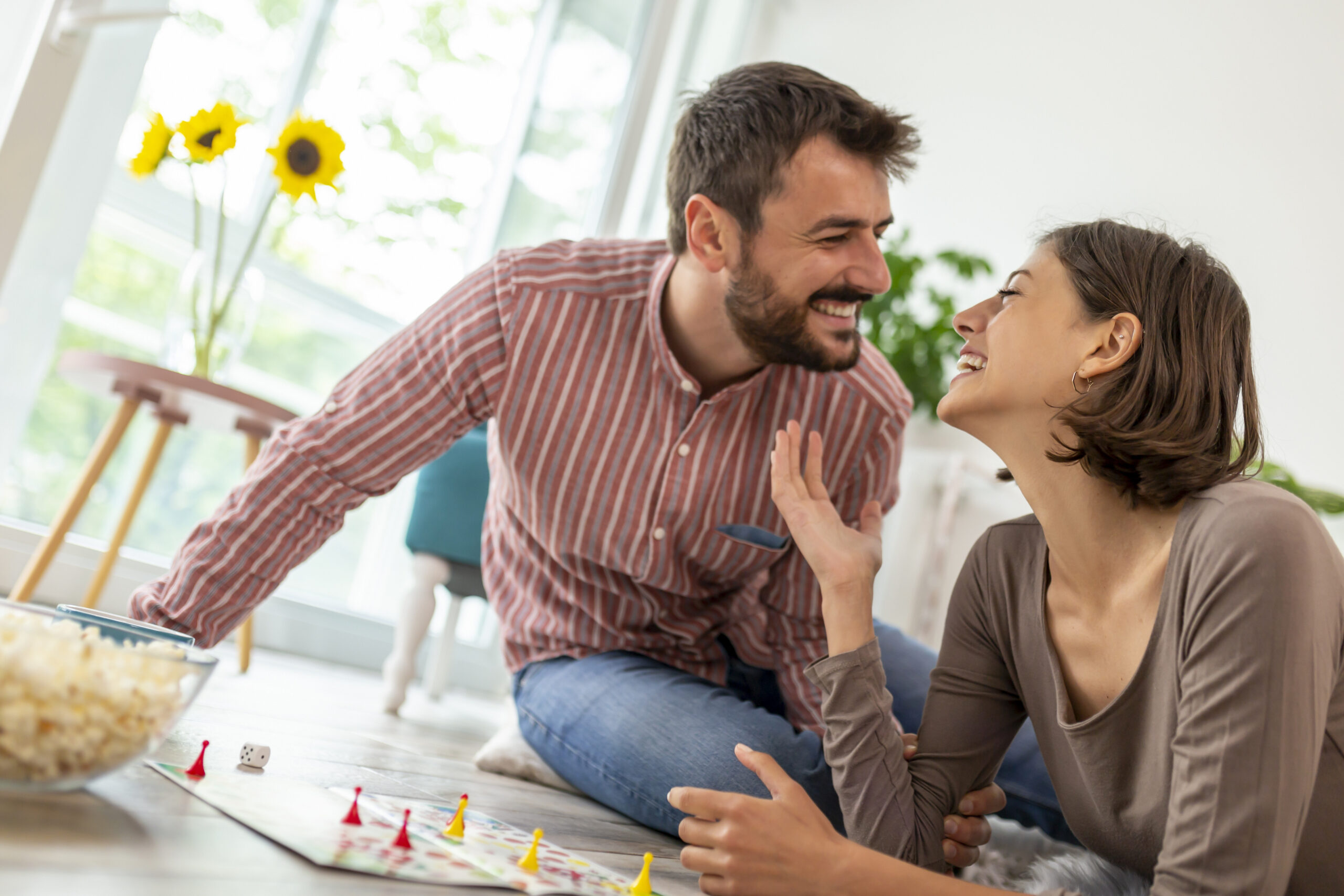 Couple having fun playing ludo board game