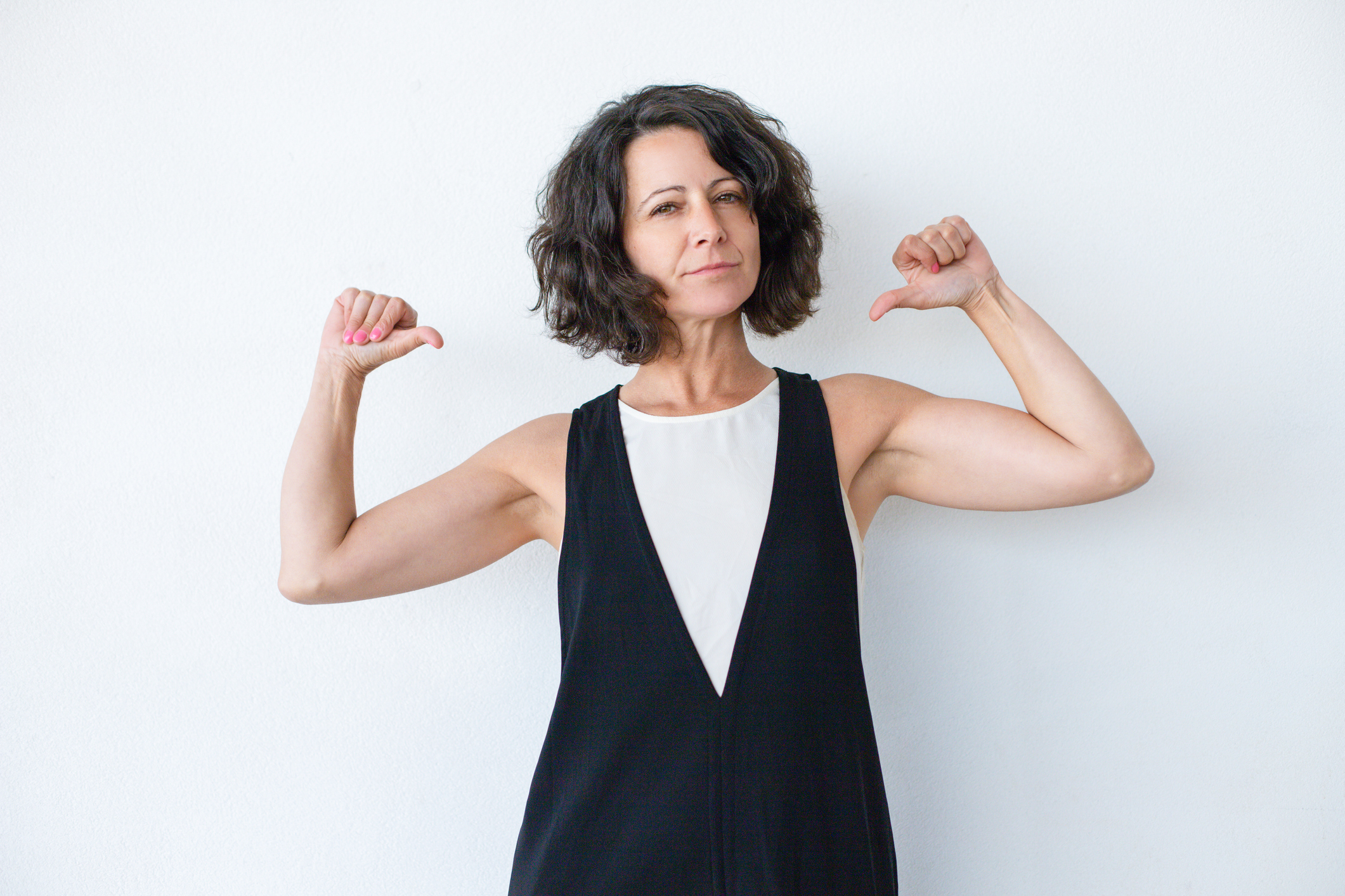 Confident woman pointing at herself