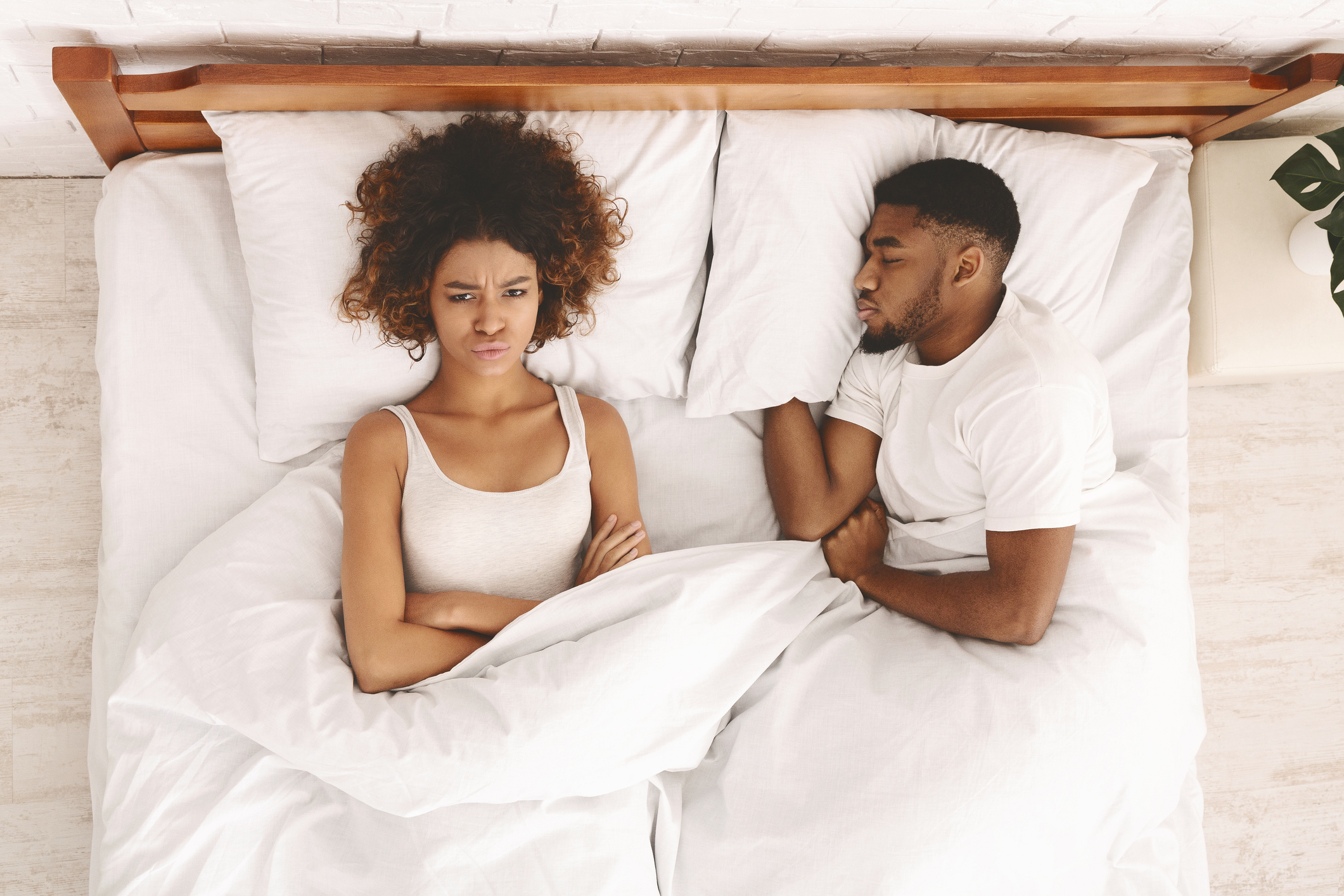 Young couple in bed having problems and crisis