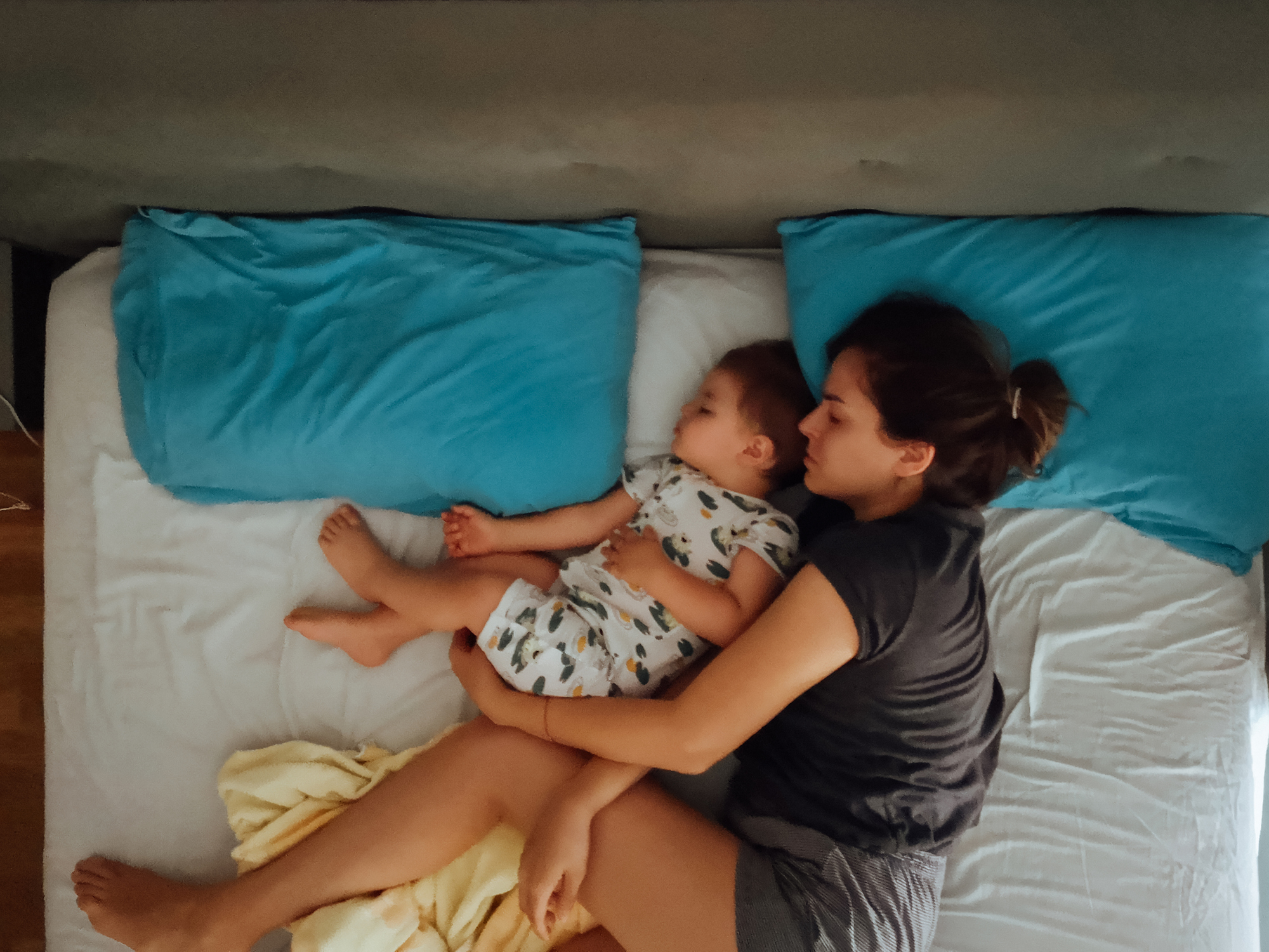 Mother and son sleeping in bed