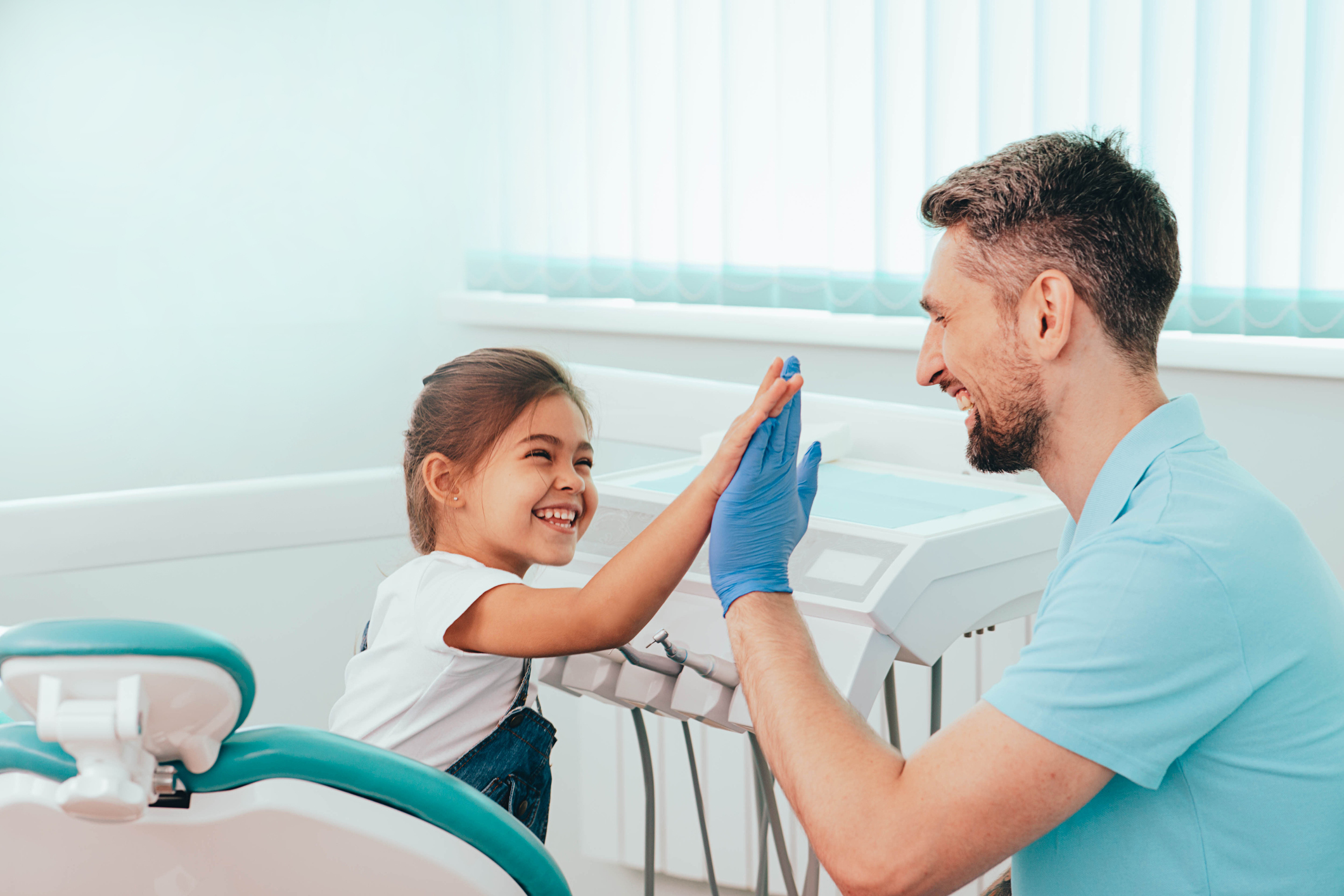 Child visit dentist. Laughing Little girl have five to dentist at dental clinic