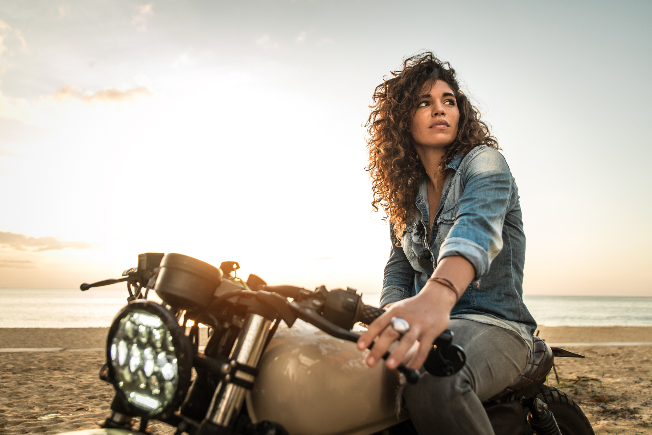 Female biker driving a cafe' racer motorbike