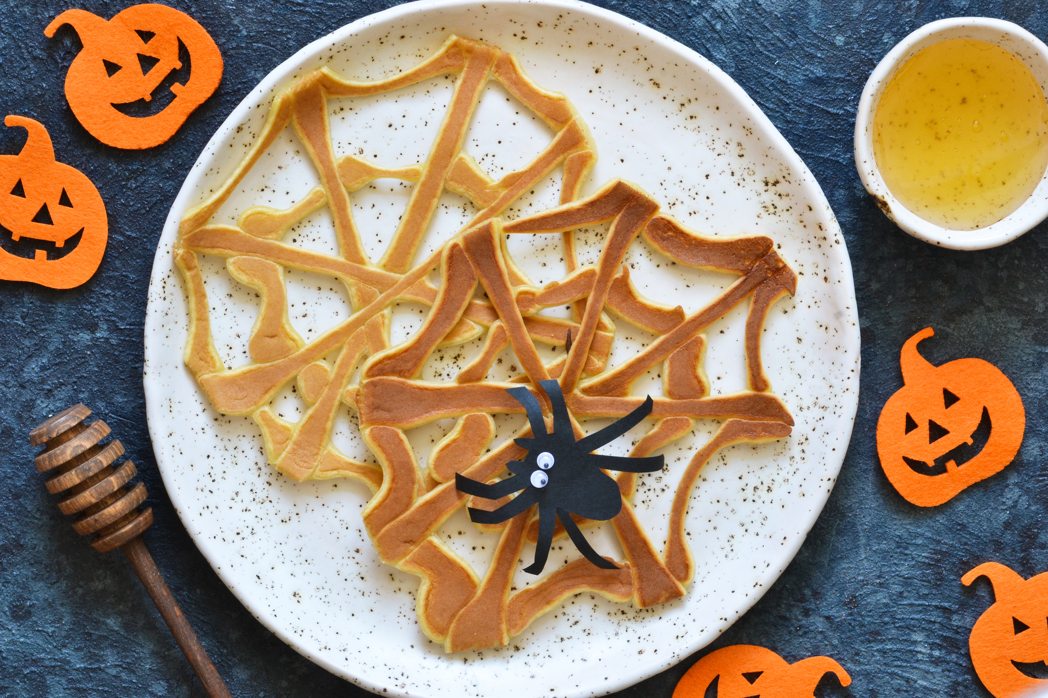 Halloween food for kids. Funny pancakes - spider web and spider. Breakfast for children.