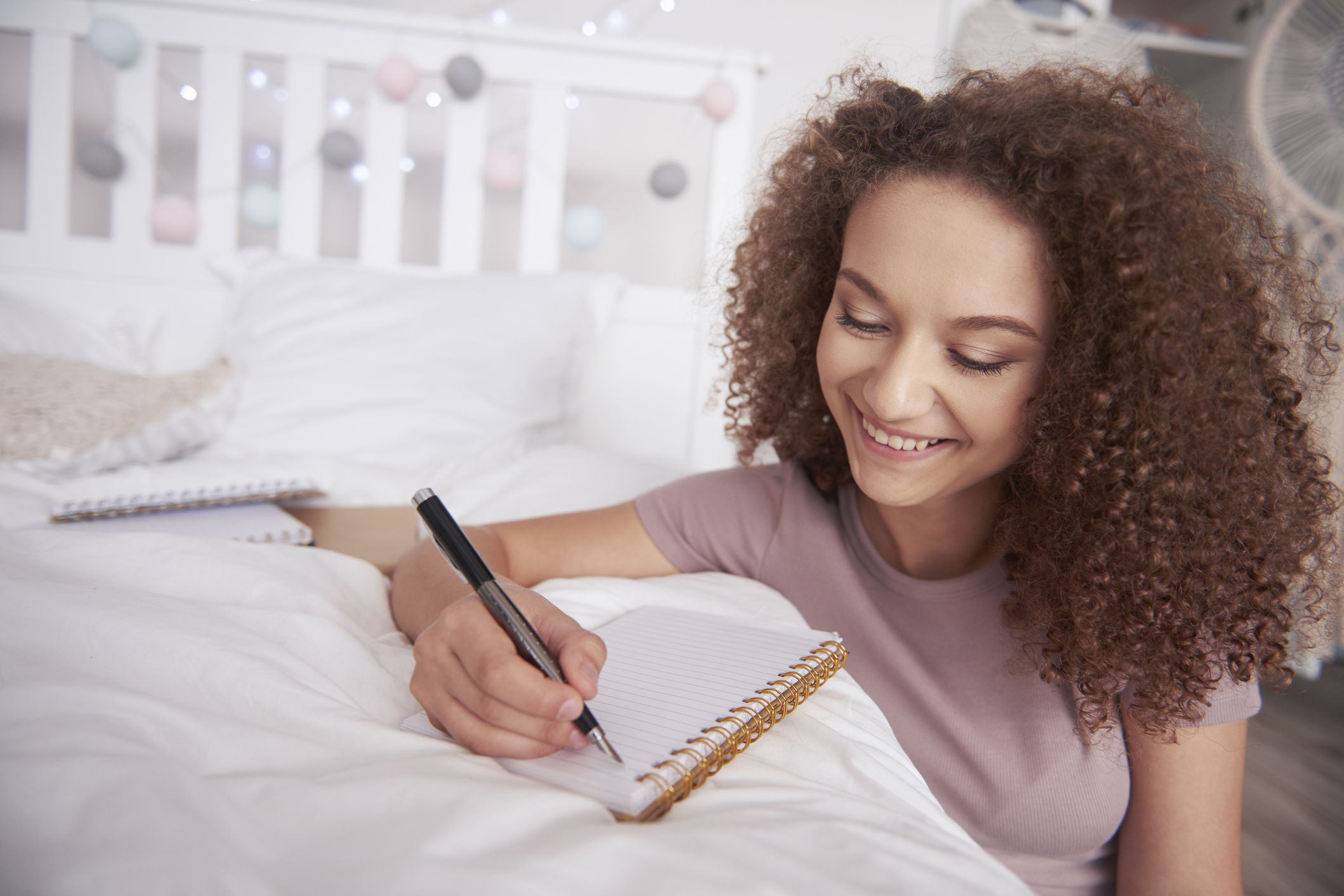 Beautiful teenage girl writing diary