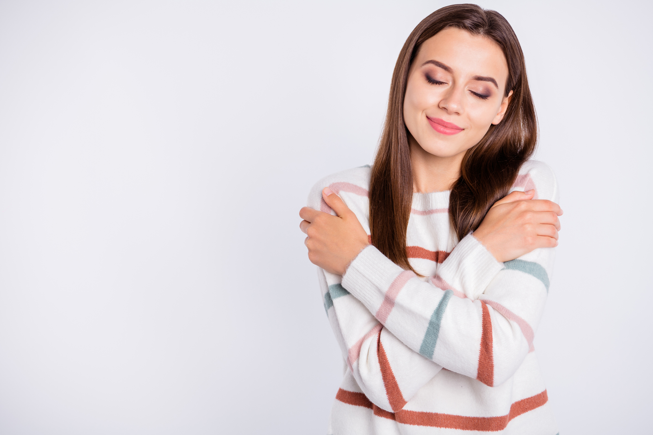 Photo of overjoyed lady crossing hands touching nice striped pullover isolated white background