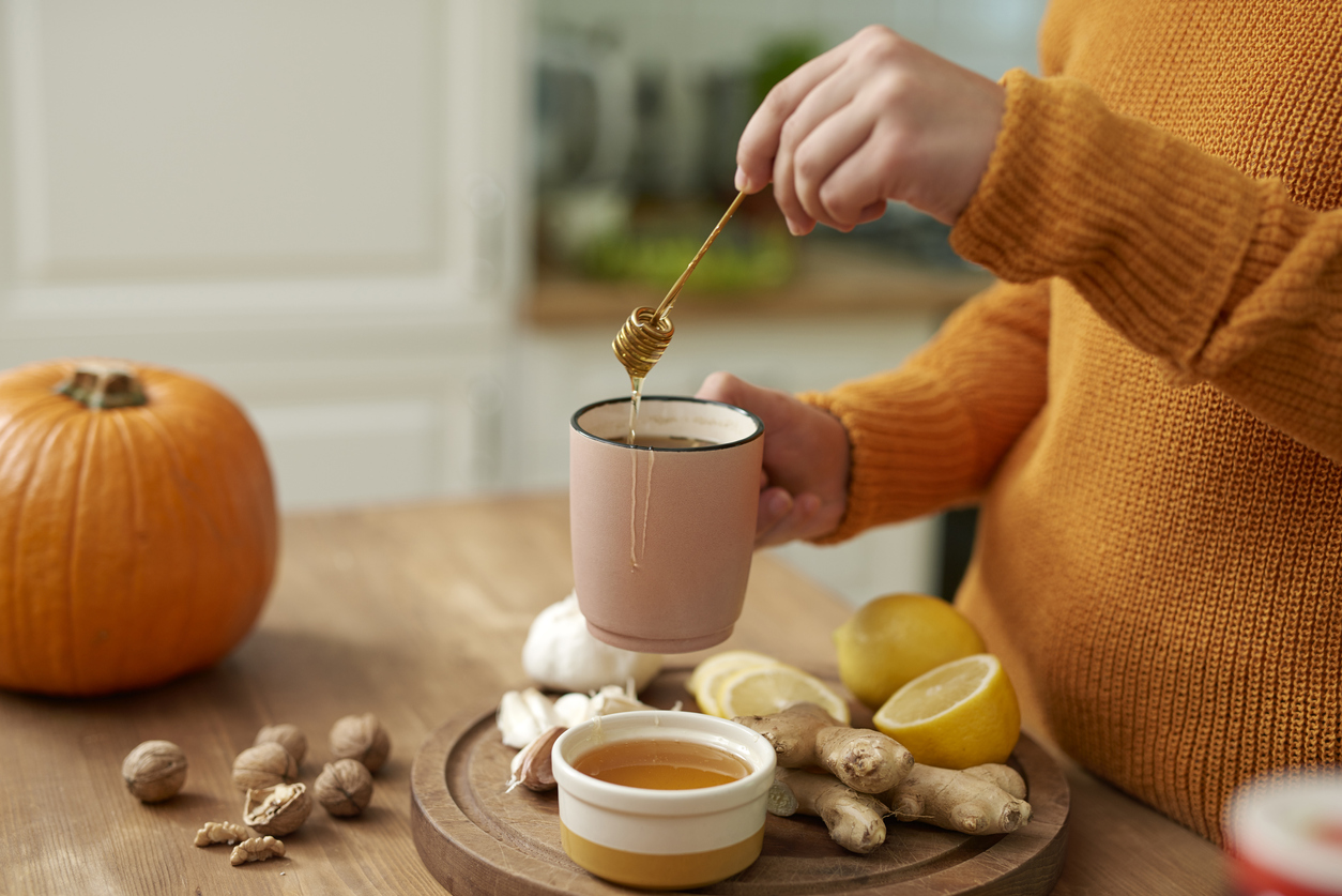 Woman making hot tea with honey